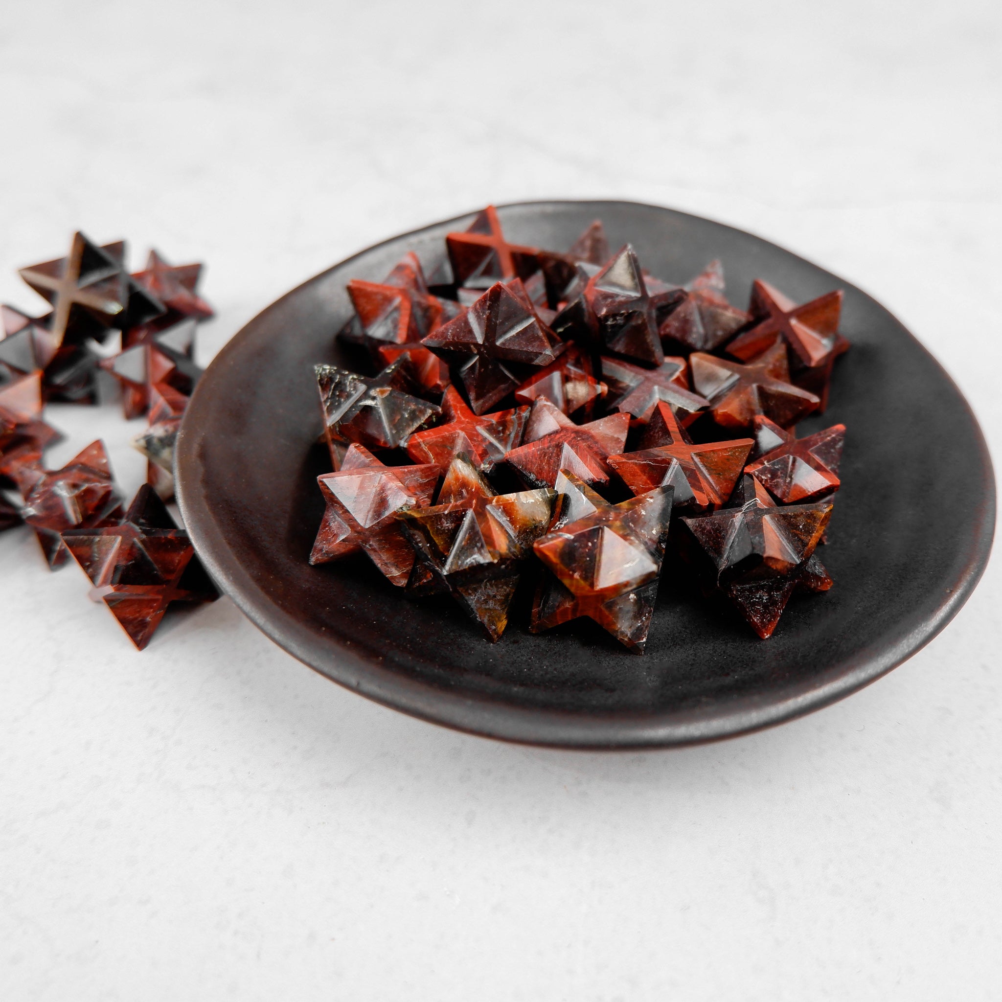Red Tigers Eye star pendant from Noctis Studio with a polished star-shaped gemstone featuring deep red and golden hues.