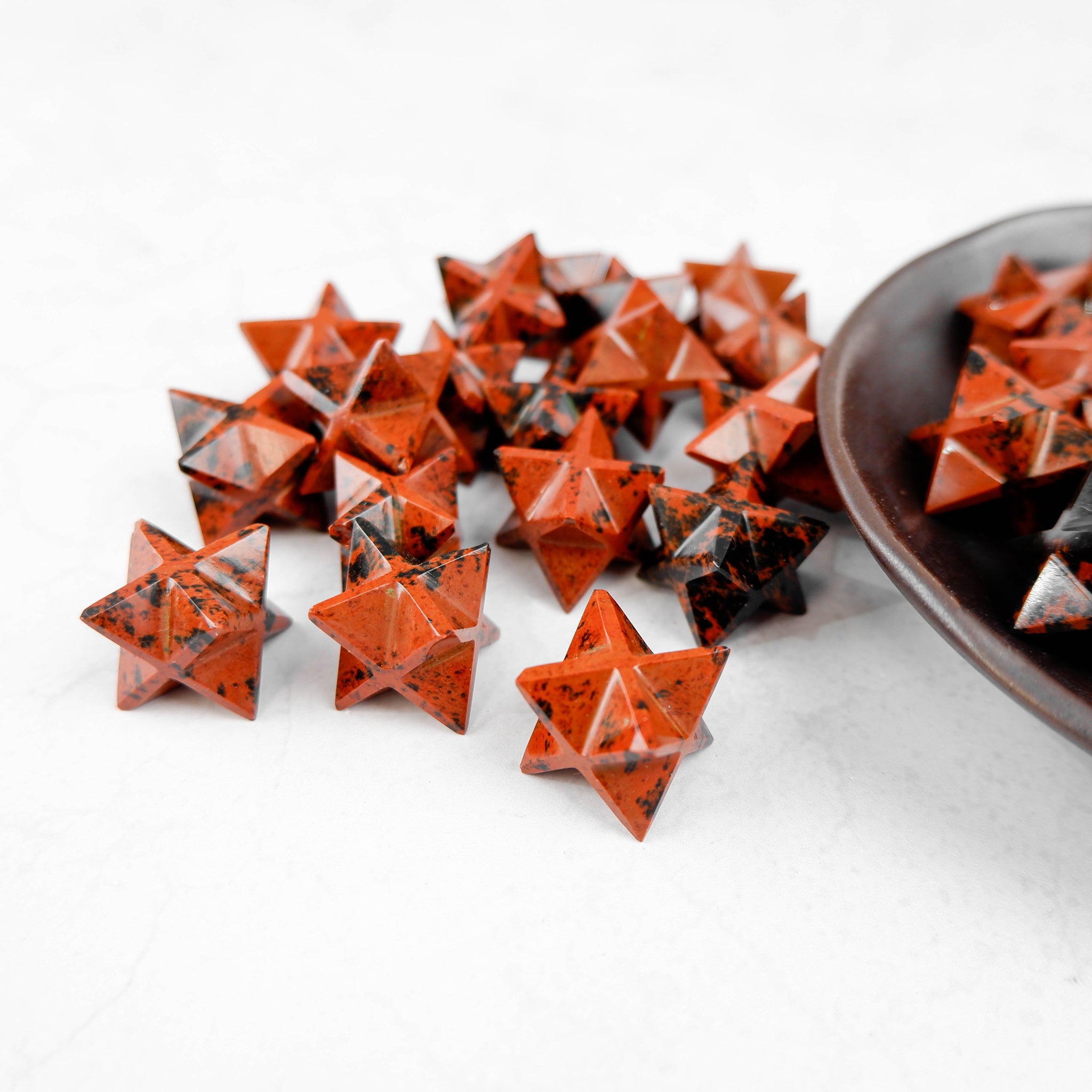 Mahogany Obsidian star sculpture by Noctis Studio, featuring a polished, dark brown and reddish stone star shape.