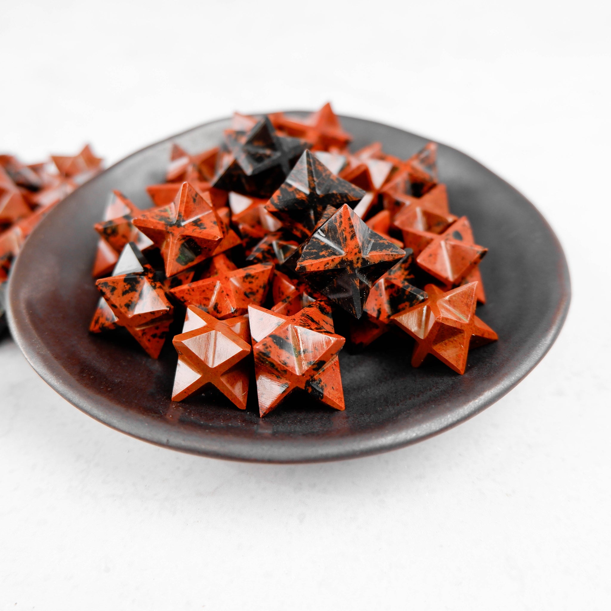 Mahogany Obsidian star sculpture by Noctis Studio, polished black and reddish-brown stone star with smooth finish.