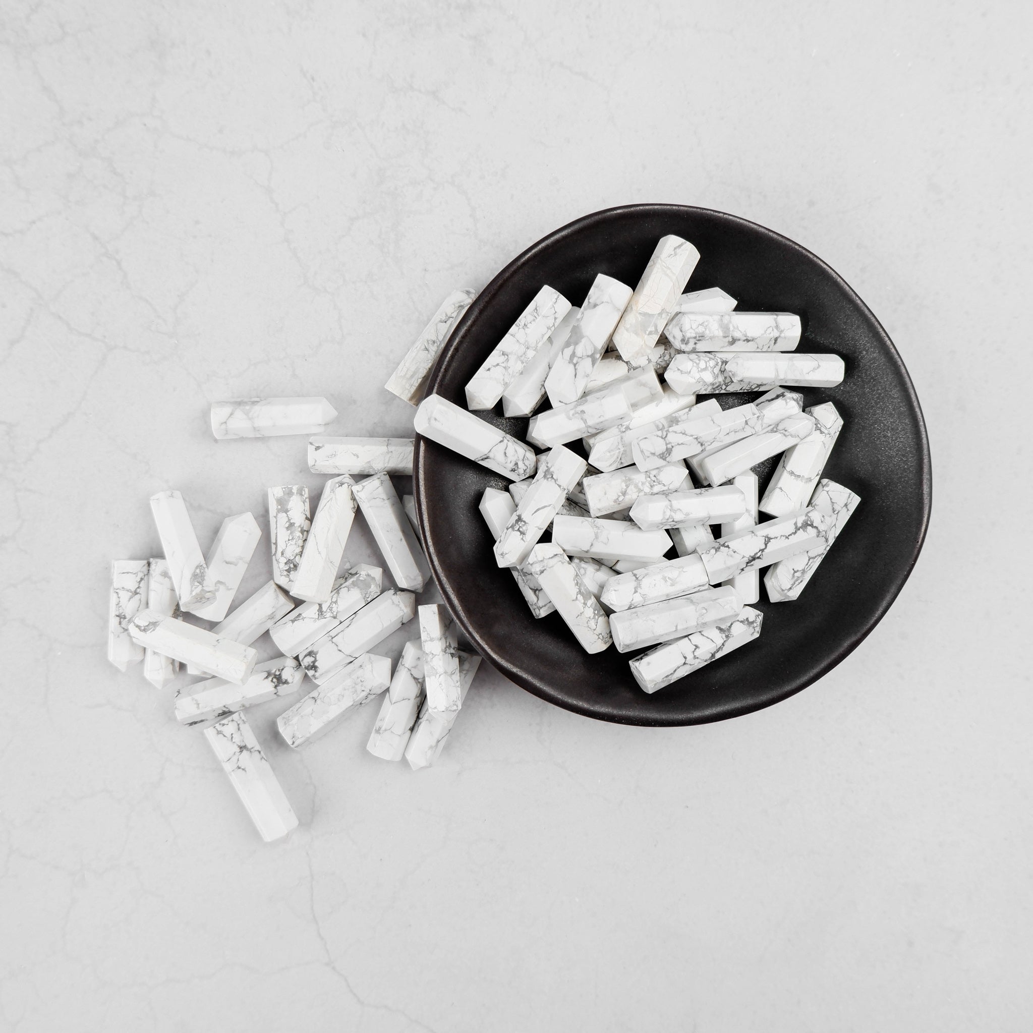 White Howlite single gridding point from Noctis Studio, a smooth, polished gemstone tool for crystal grid arrangements.