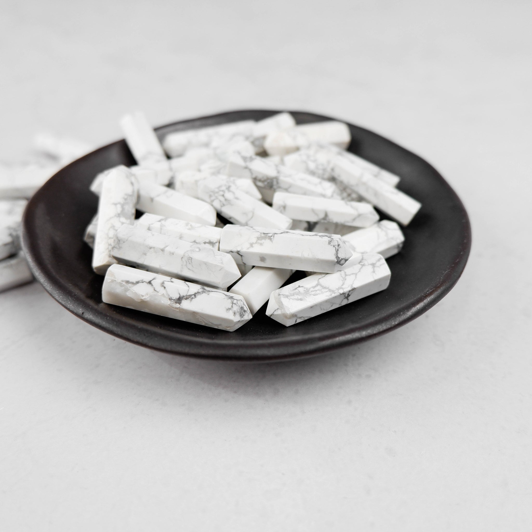 White Howlite single gridding point from Noctis Studio, featuring polished white stone with smooth, pointed shape for crystal grid setups.
