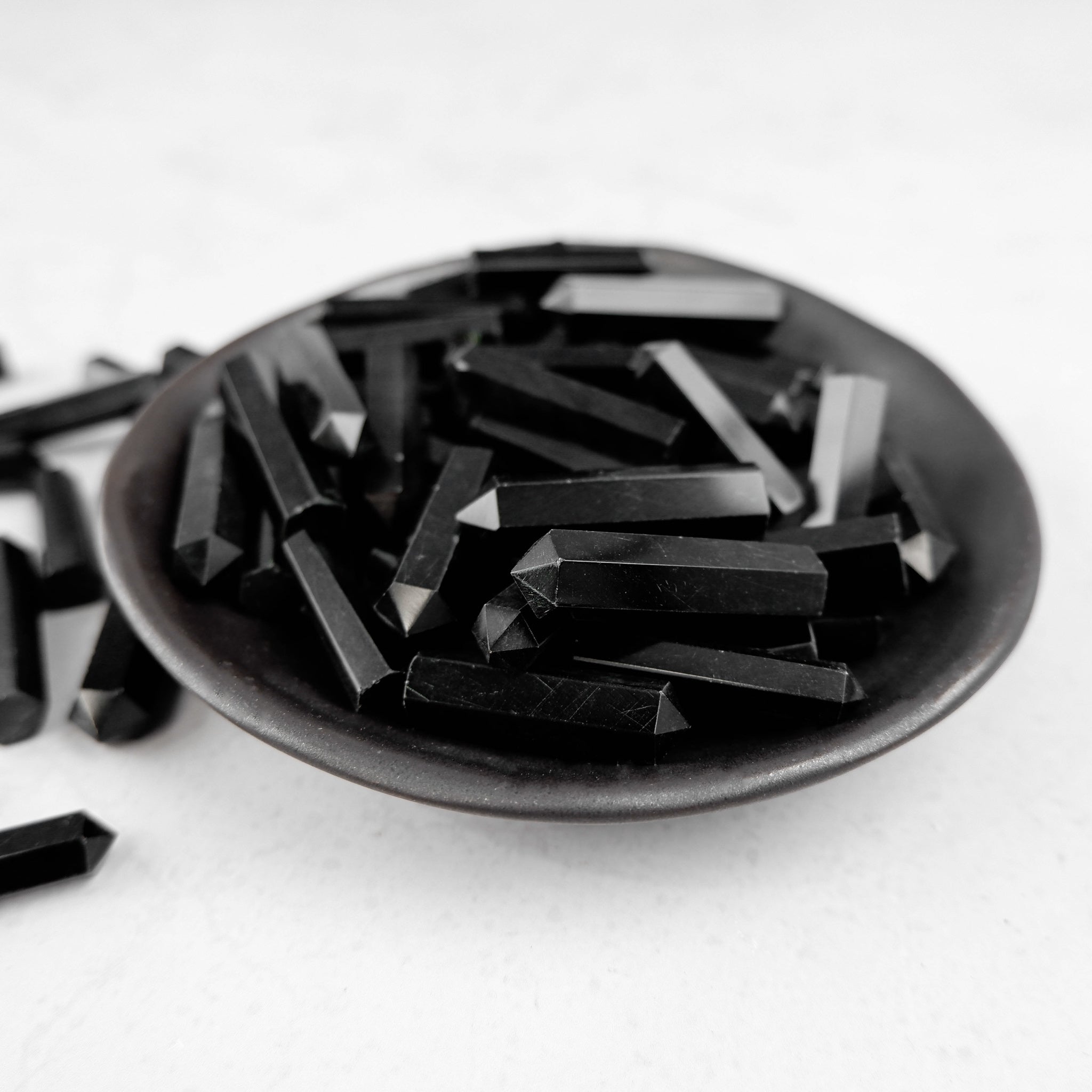 Obsidian single gridding point by Noctis Studio, featuring a sleek black design and precise tip for detailed work.