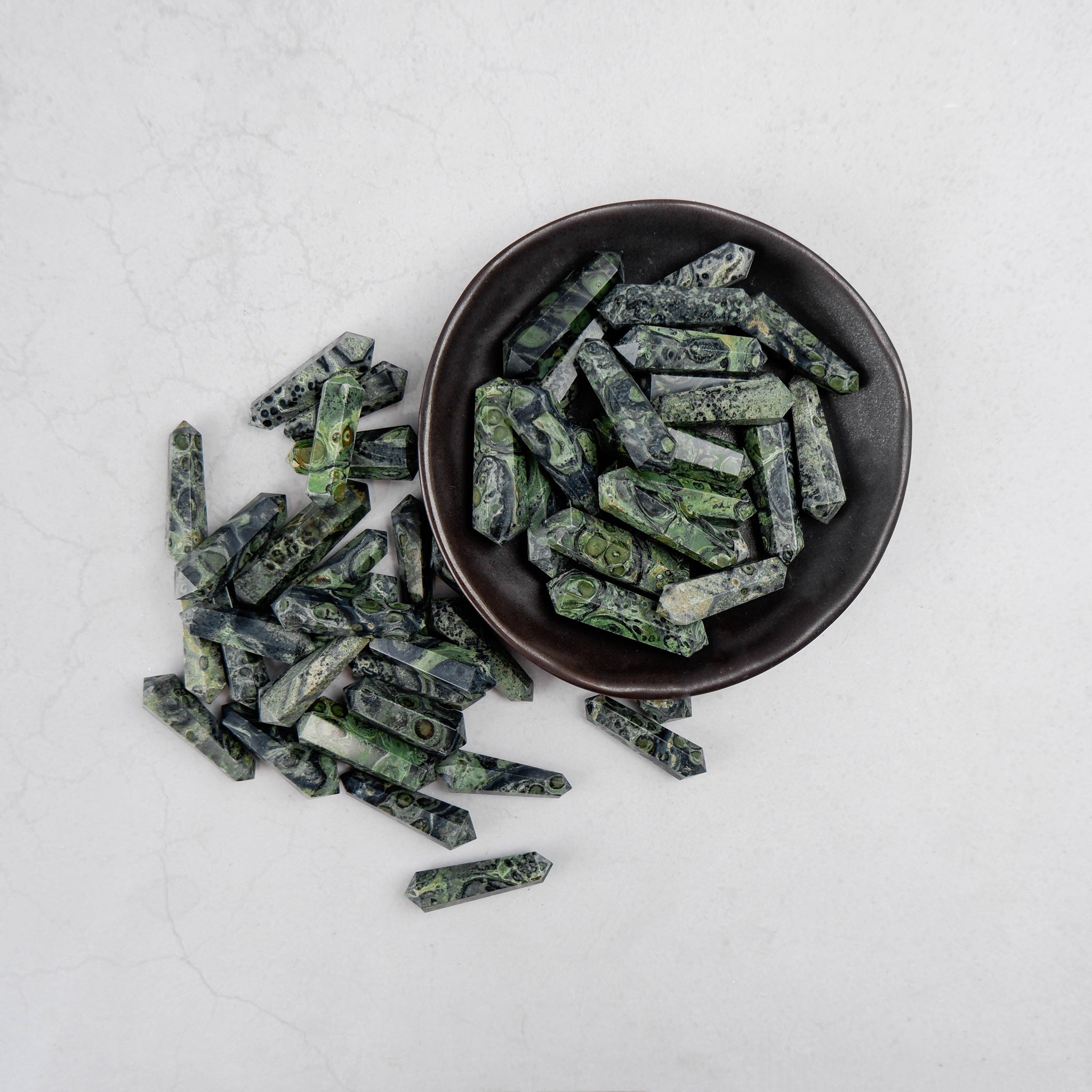 Kambaba Jasper double gridding point from Noctis Studio featuring polished stone with green and black swirling patterns.