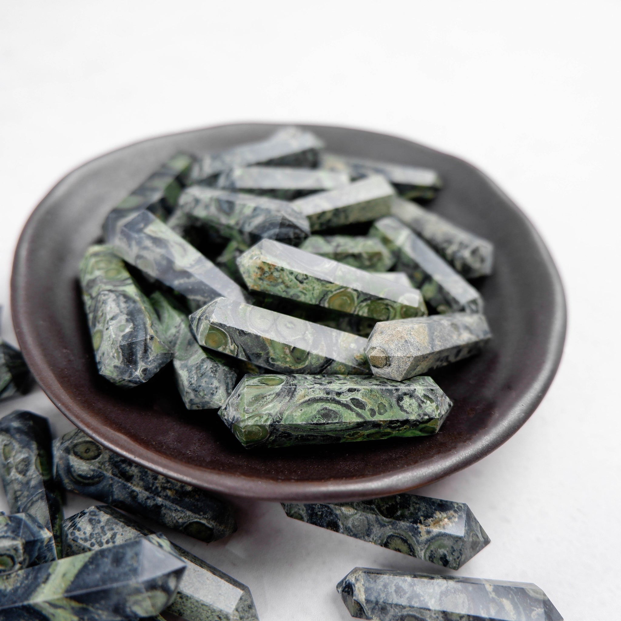 Noctis Studio Kambaba Jasper Double Gridding Point, polished gemstone tool with green and black swirling patterns, used for crystal healing