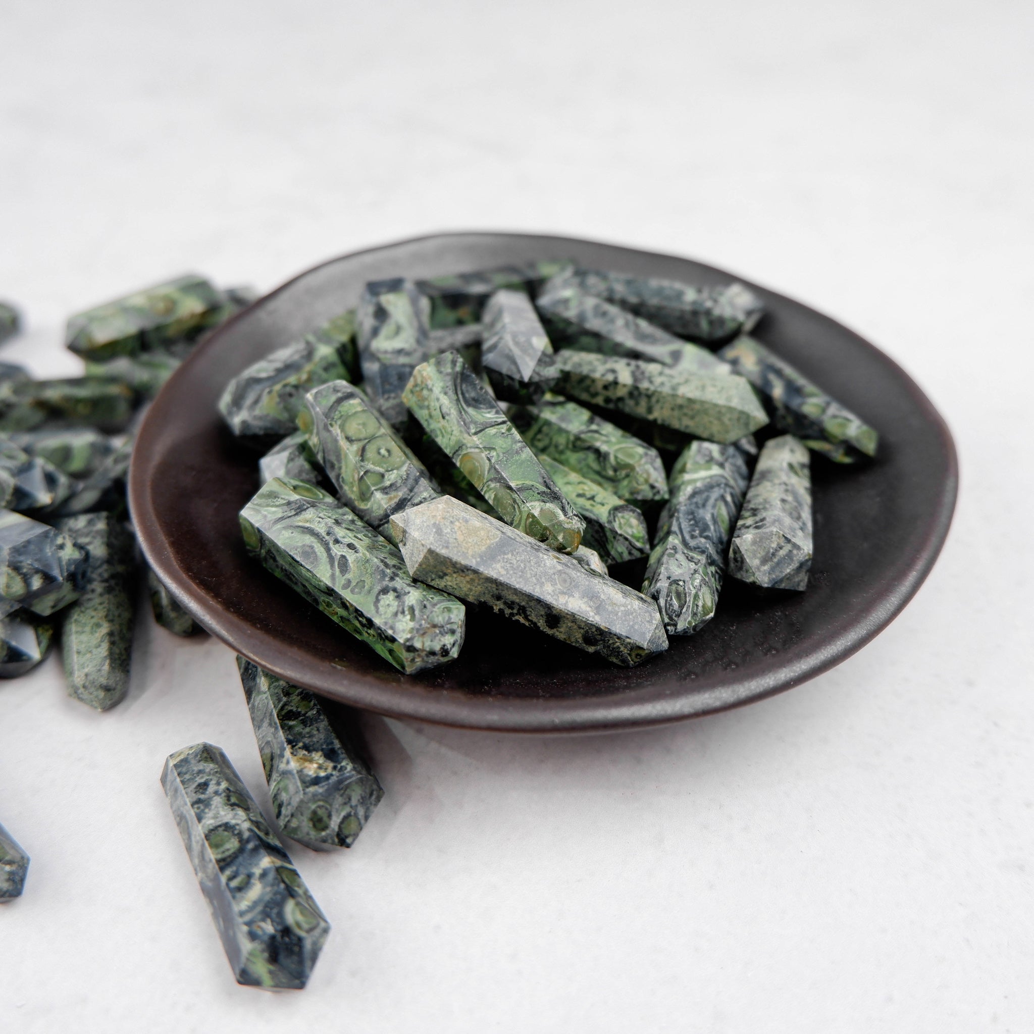 Kambaba Jasper double gridding point from Noctis Studio, showcasing polished green and black patterned gemstone specimen.