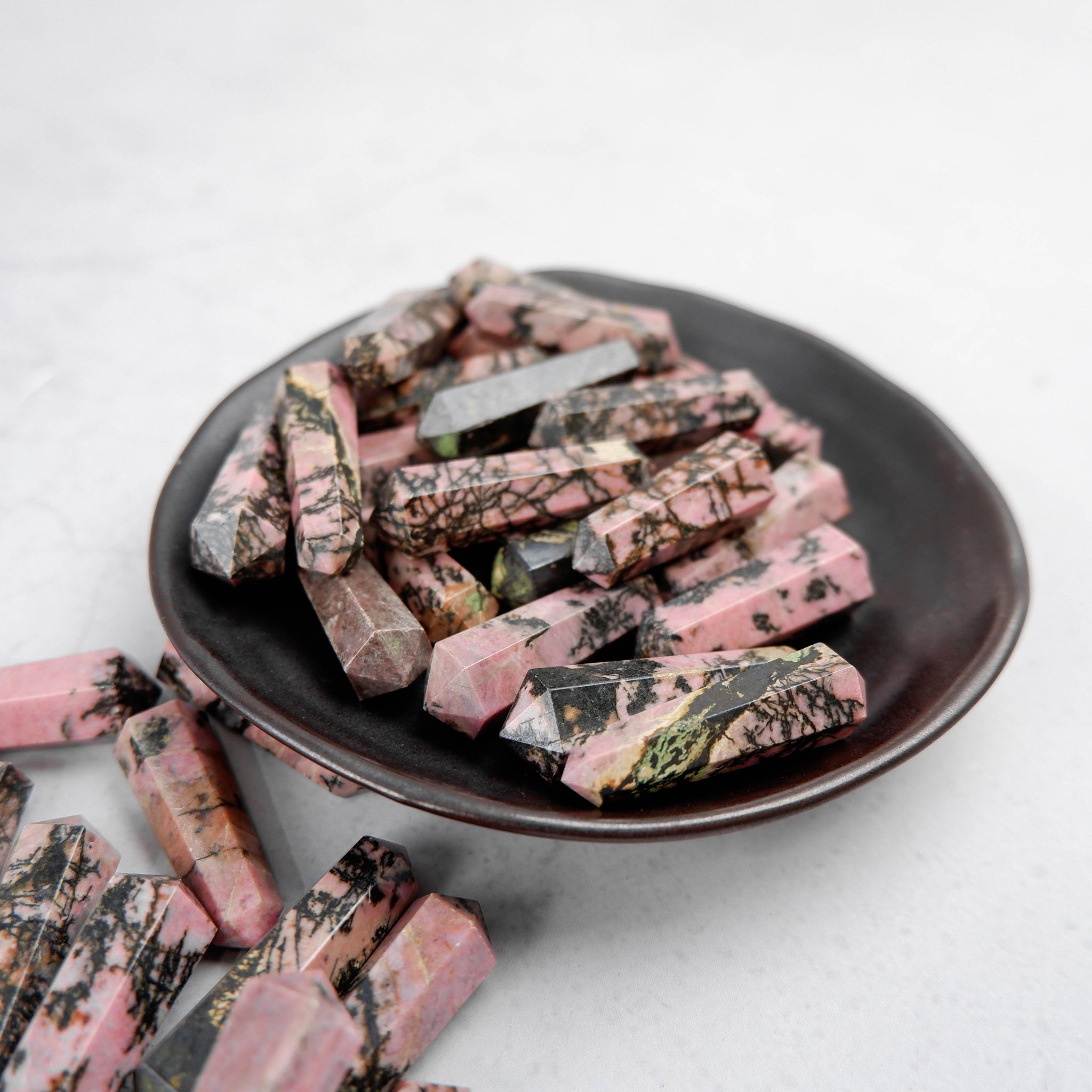 Rhodonite double gridding point from Noctis Studio, featuring polished pink and black stone with pointed tips for energy work.