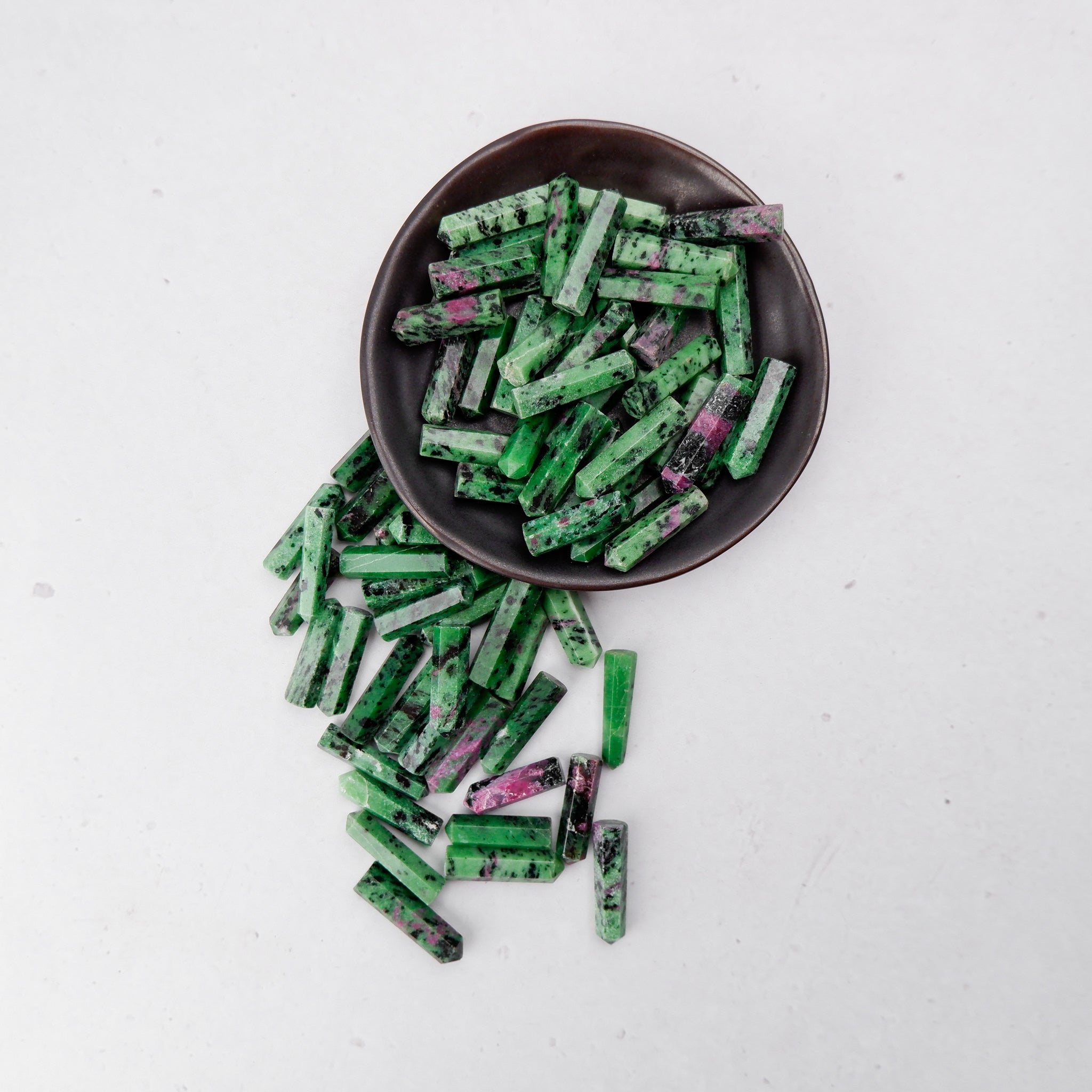 Ruby in Zoisite single gridding point from Noctis Studio, showcasing the vibrant gemstone with pointed crystal tip.