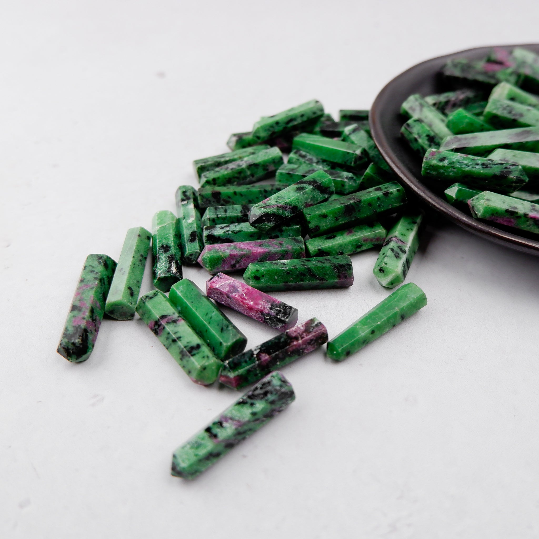 Ruby in Zoisite single gridding point from Noctis Studio, showing a polished gemstone with vibrant red and green mineral patterns.