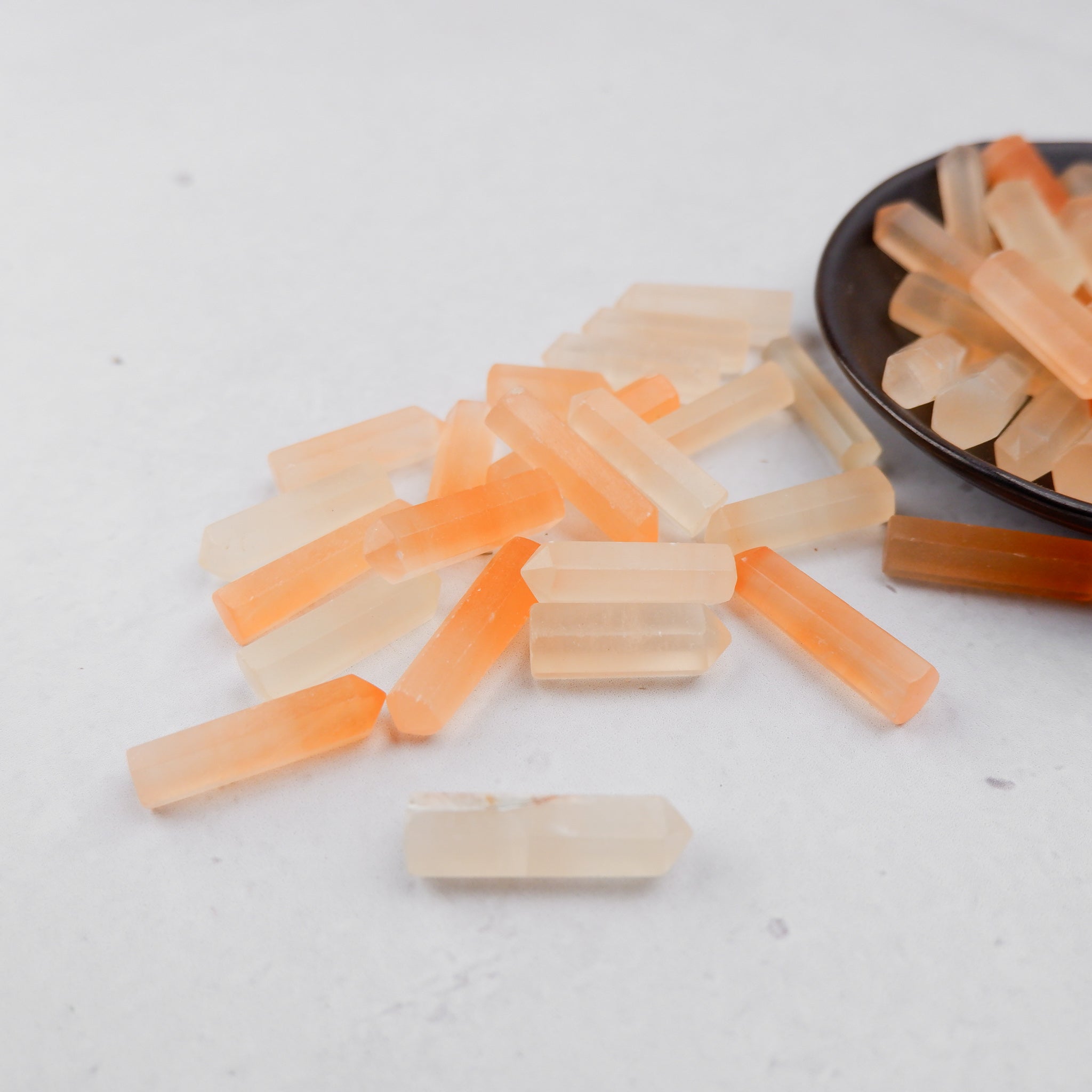 Orange Selenite single gridding point from Noctis Studio, showing a polished mineral crystal with a pointed tip for energy work.