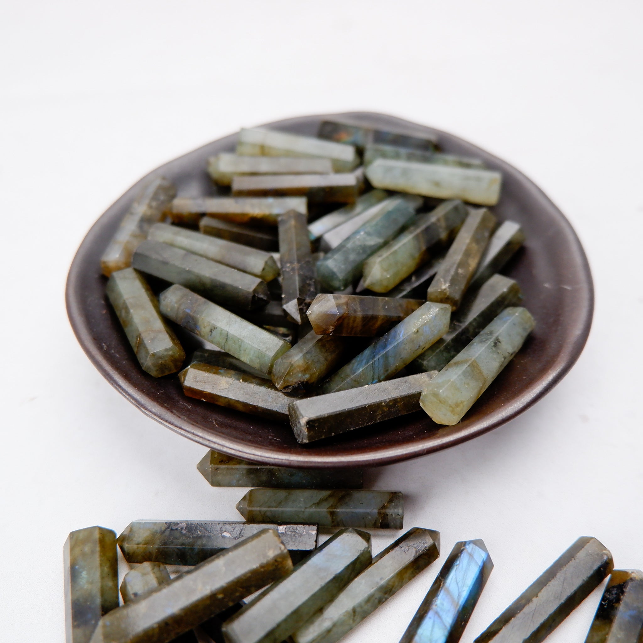 Labradorite single gridding point by Noctis Studio showing a polished, elongated gemstone with iridescent blue and green flashes.