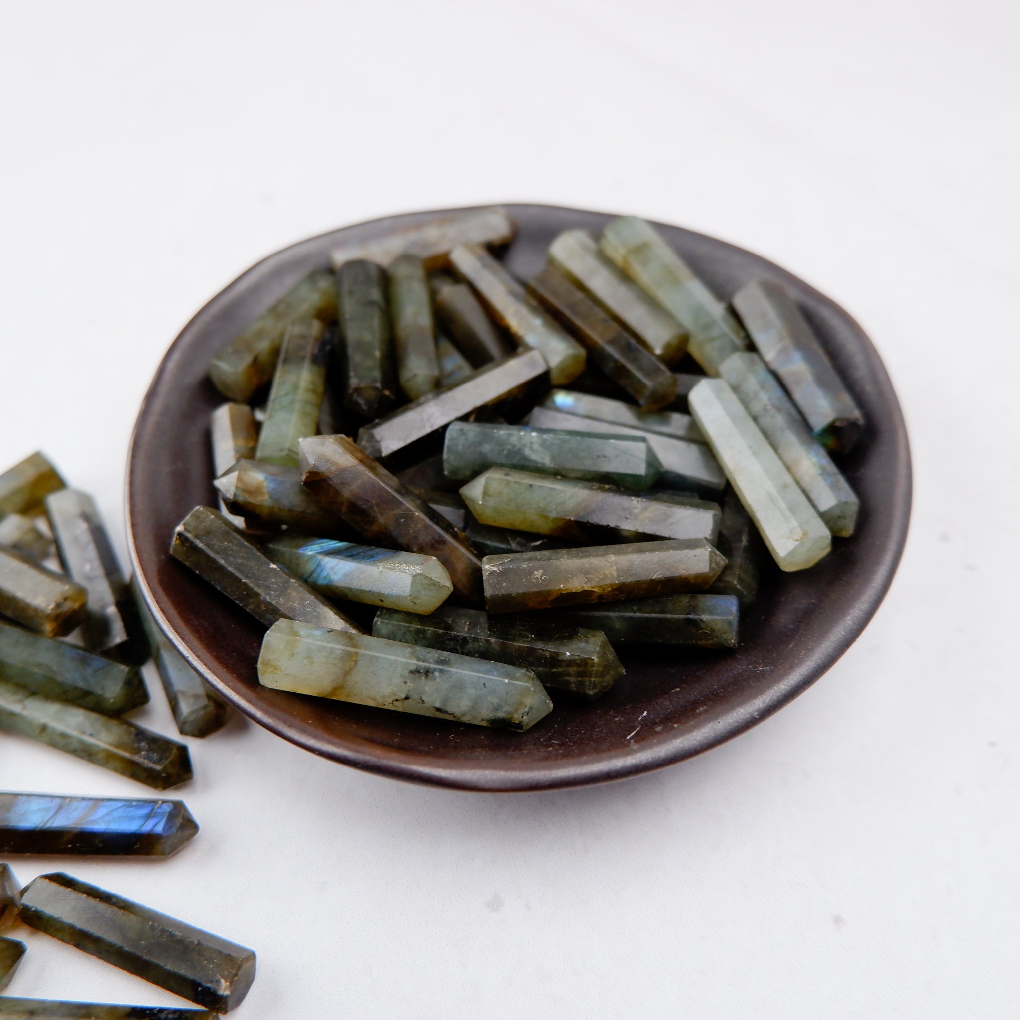 Labradorite single gridding point from Noctis Studio featuring iridescent blue and green hues and a pointed shape for crystal healing.