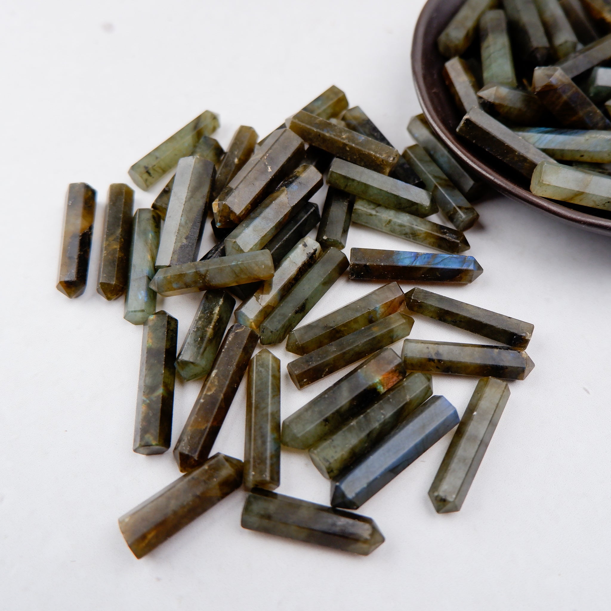 Labradorite single gridding point gemstone from Noctis Studio, showcasing iridescent blue and green hues with polished surface.