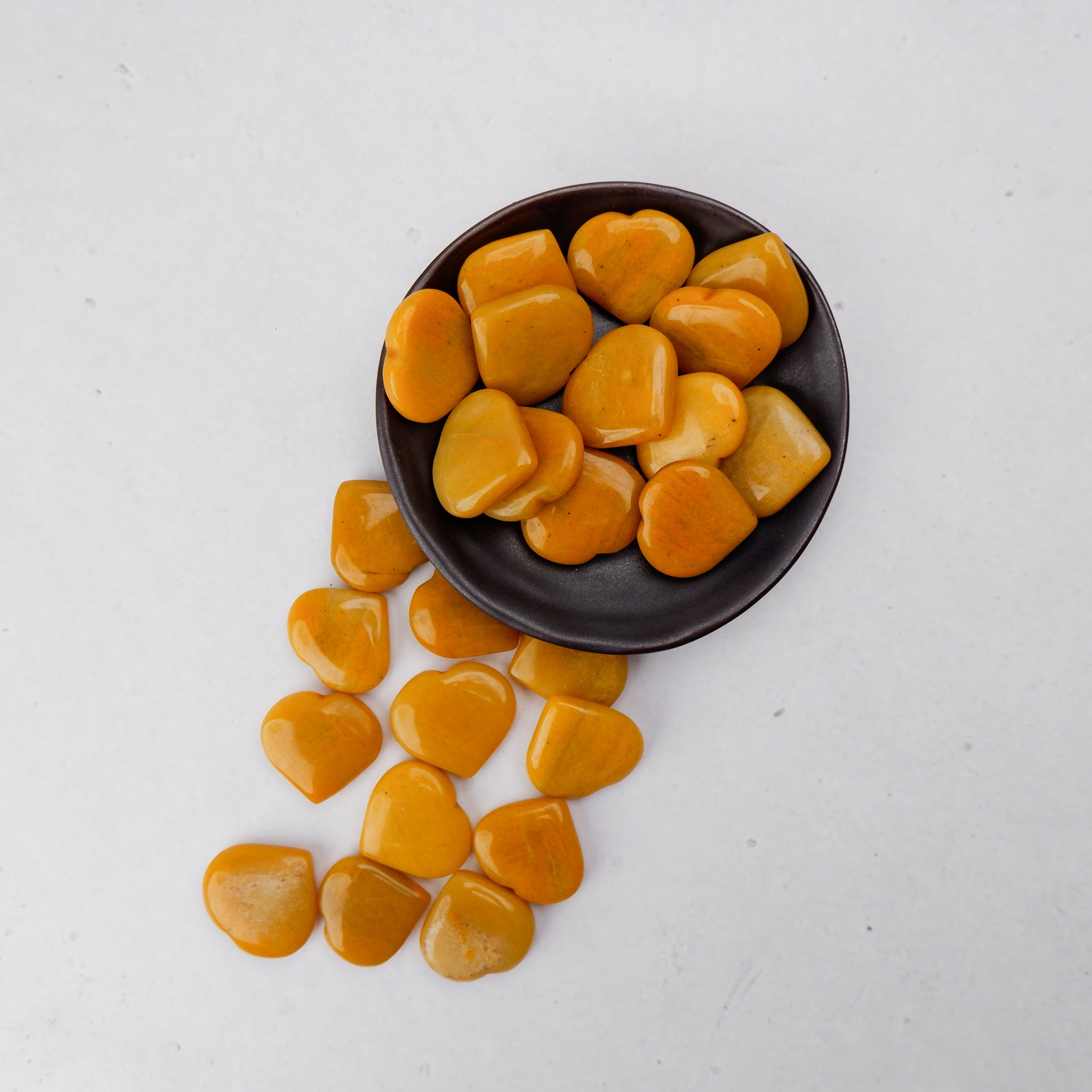 Yellow Aventurine heart sculpture by Noctis Studio, smooth polished gemstone with vibrant yellow color and natural stone patterns.