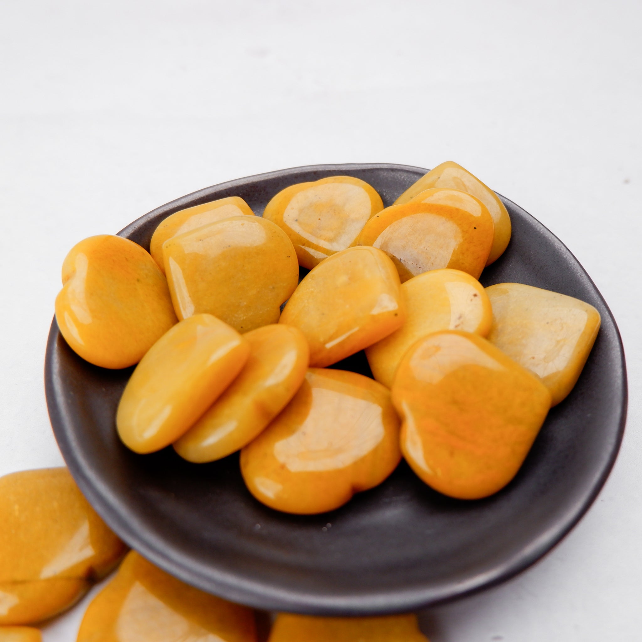 Yellow Aventurine heart sculpture by Noctis Studio, polished gemstone with smooth, vibrant yellow surface and natural stone patterns.