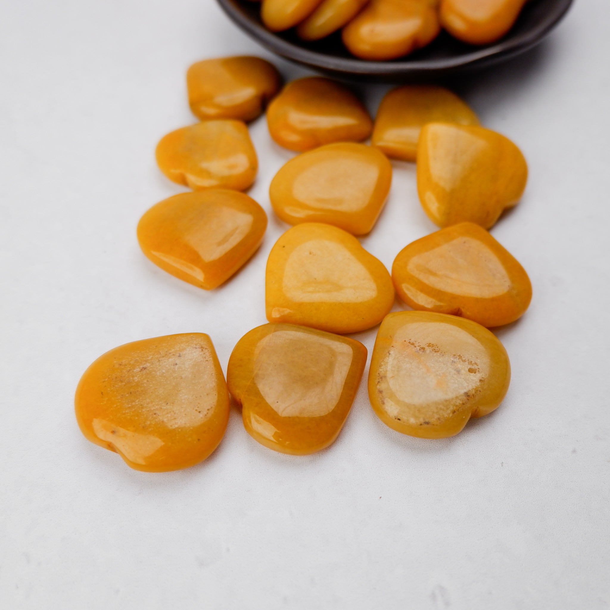 Yellow Aventurine heart gemstone sculpture by Noctis Studio, polished and smooth with a vibrant yellow color.