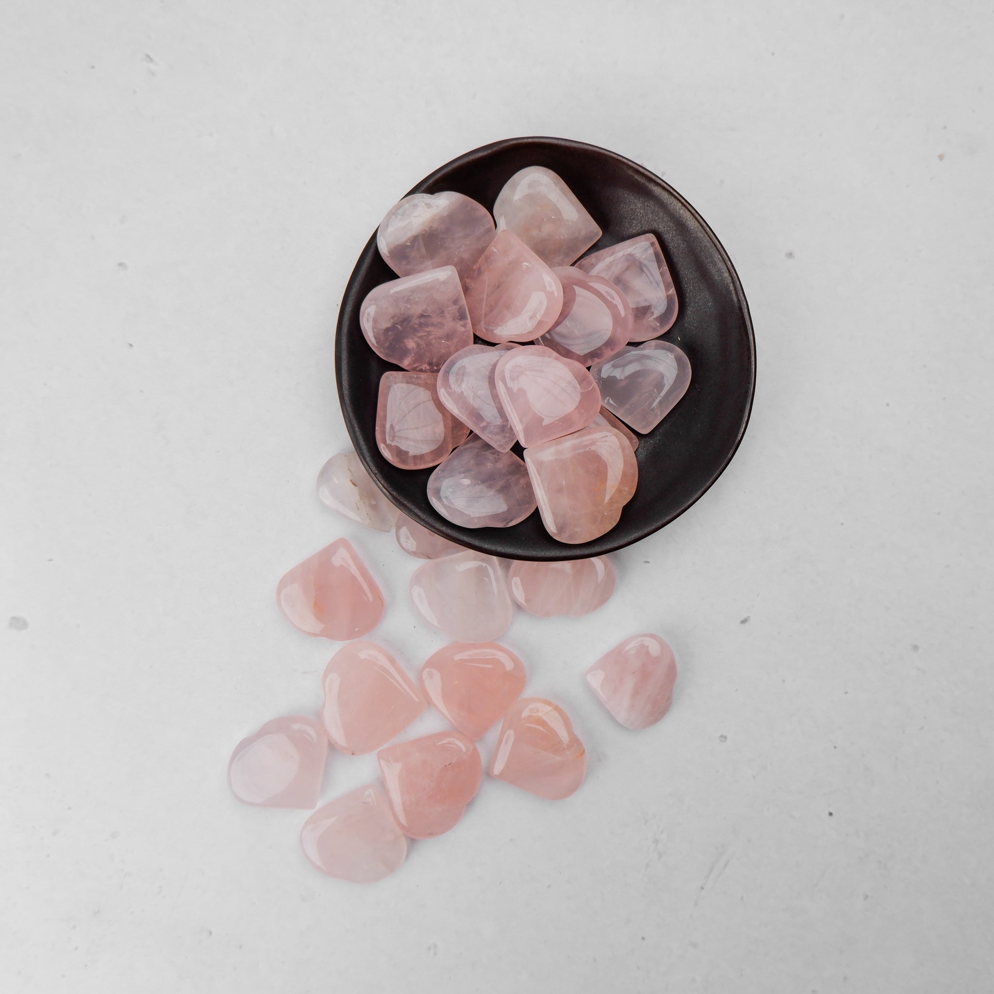 Pink rose quartz heart sculpture by Noctis Studio, smooth polished stone with natural veining and a rounded, heart-shaped form.
