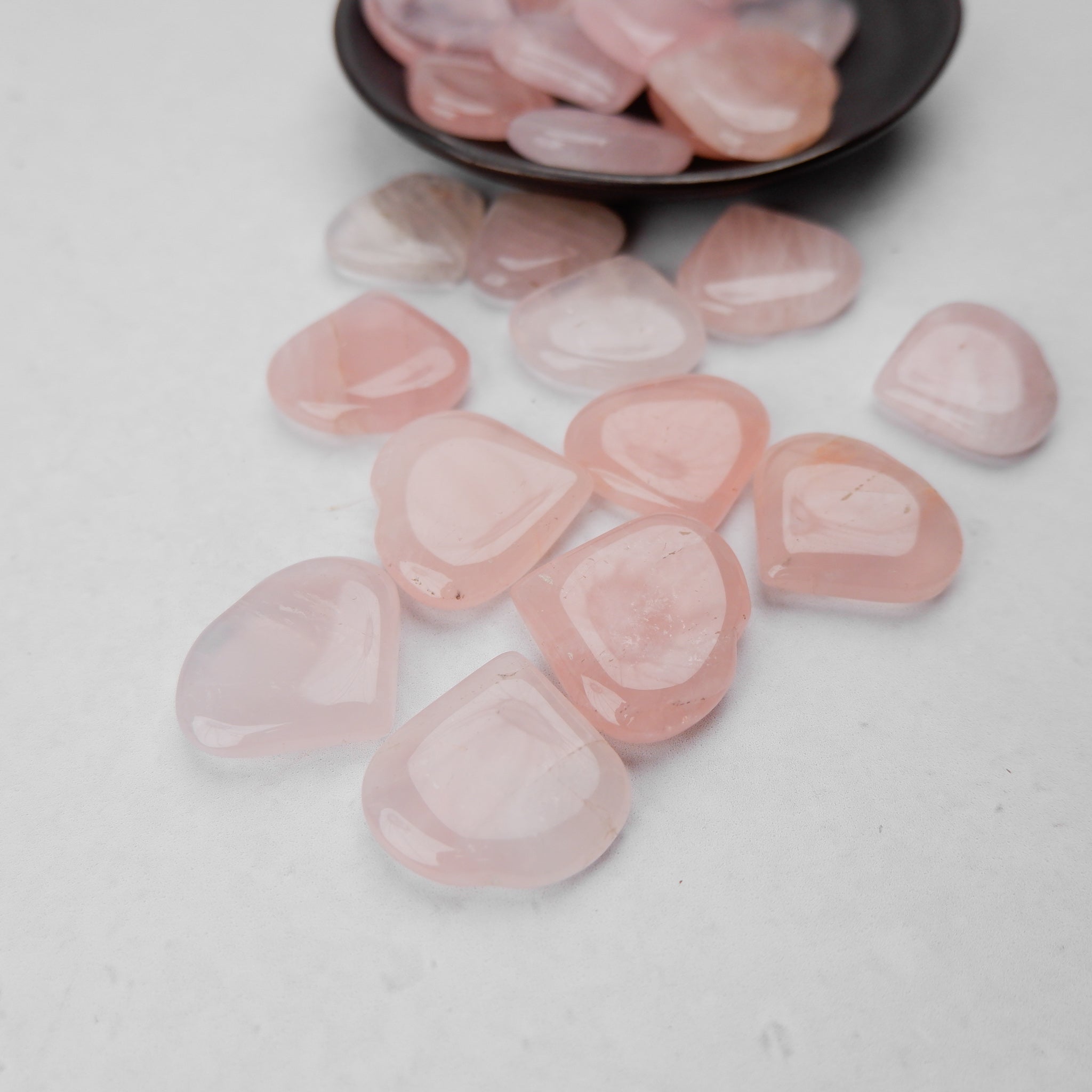 Pink rose quartz heart sculpture from Noctis Studio, polished gemstone with smooth, rounded shape and natural crystal coloration.