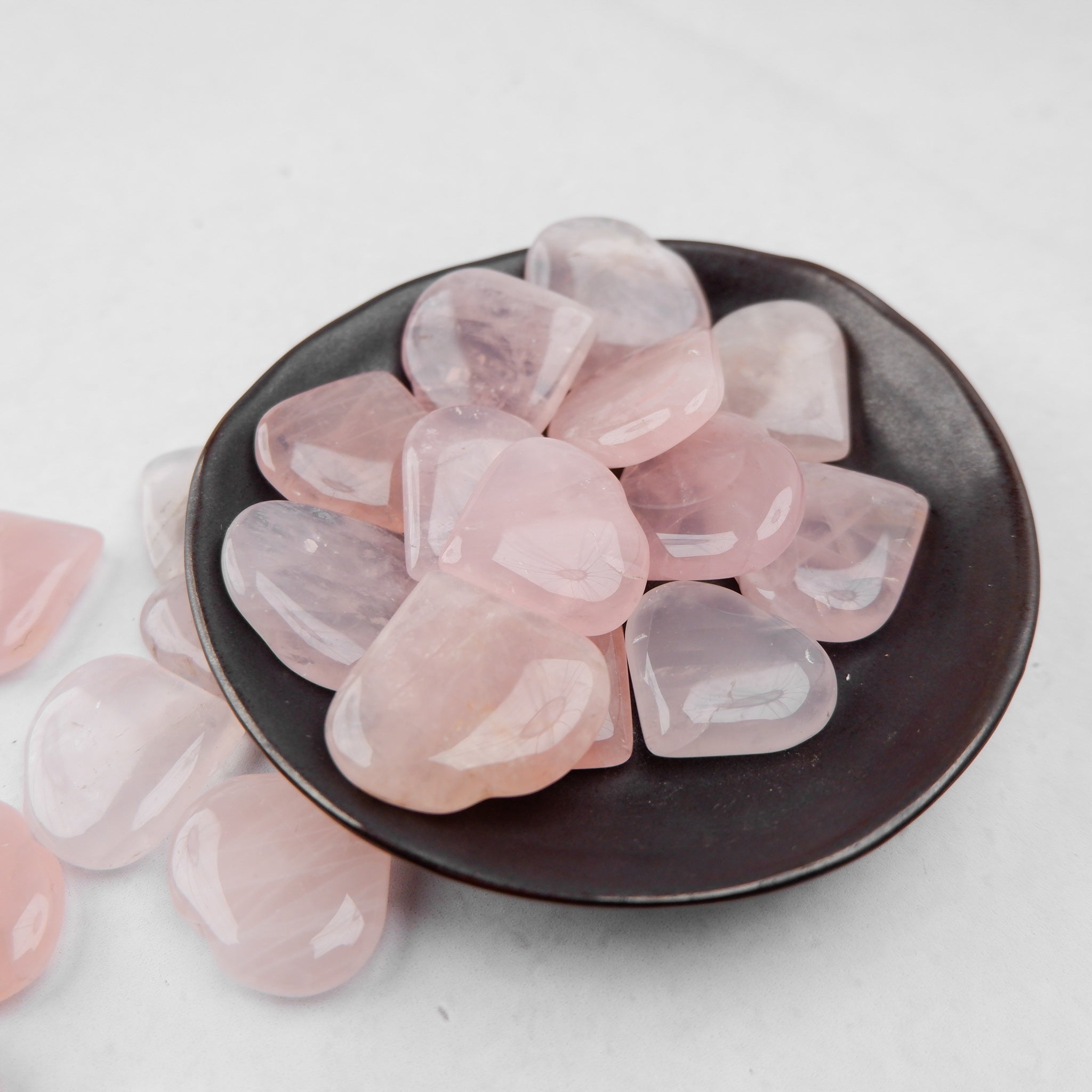 Polished rose quartz heart gemstone by Noctis Studio, smooth and translucent with gentle pink hues.