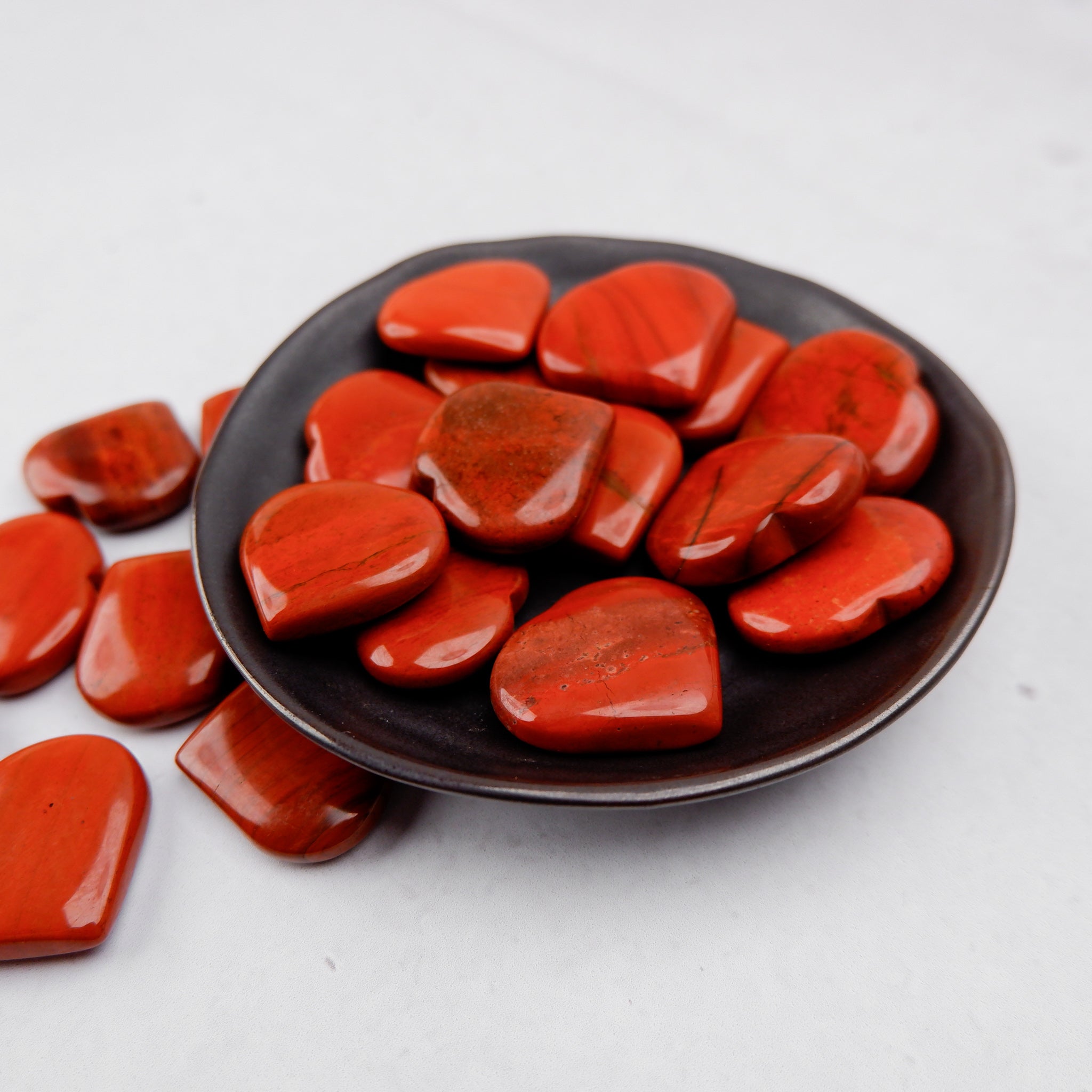 Red Jasper heart sculpture by Noctis Studio, polished gemstone with rich red color and smooth, heart-shaped design.