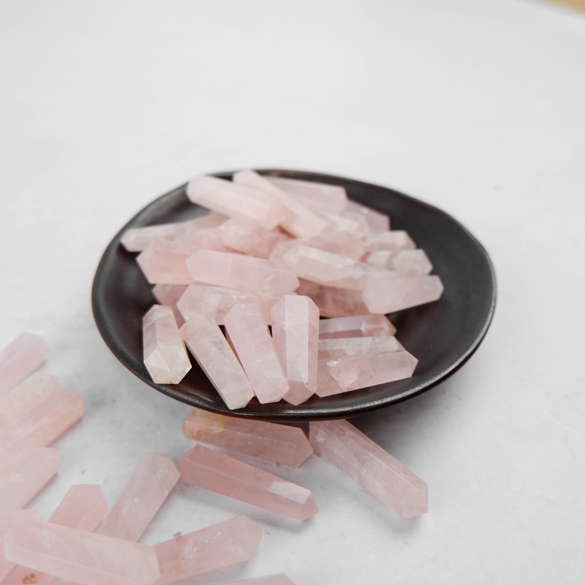 Rose Quartz double gridding point from Noctis Studio, a smooth, polished skincare tool for facial massage and skincare application.