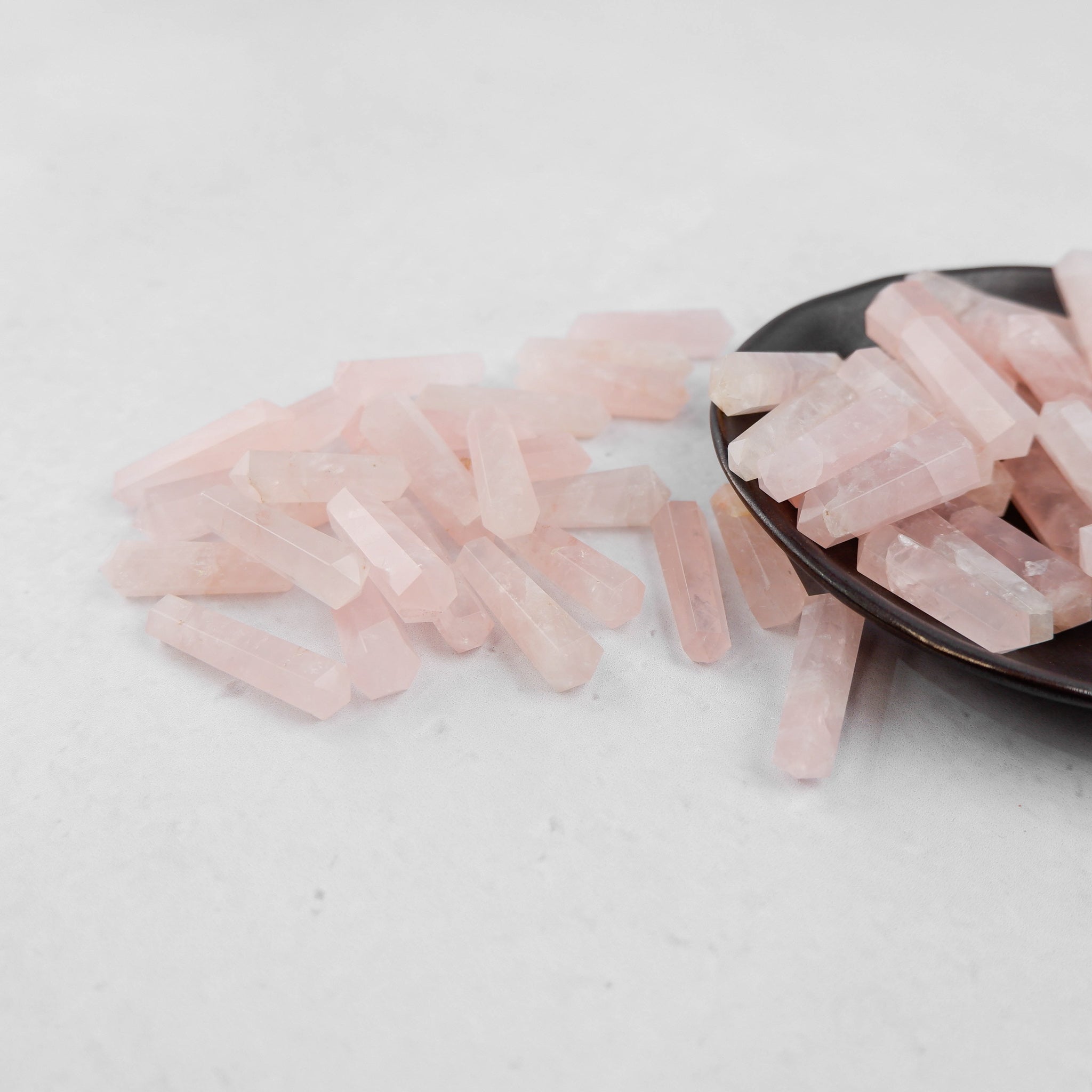 Rose Quartz Double Gridding Point from Noctis Studio, a polished crystal tool with pointed ends for facial and skin massage.