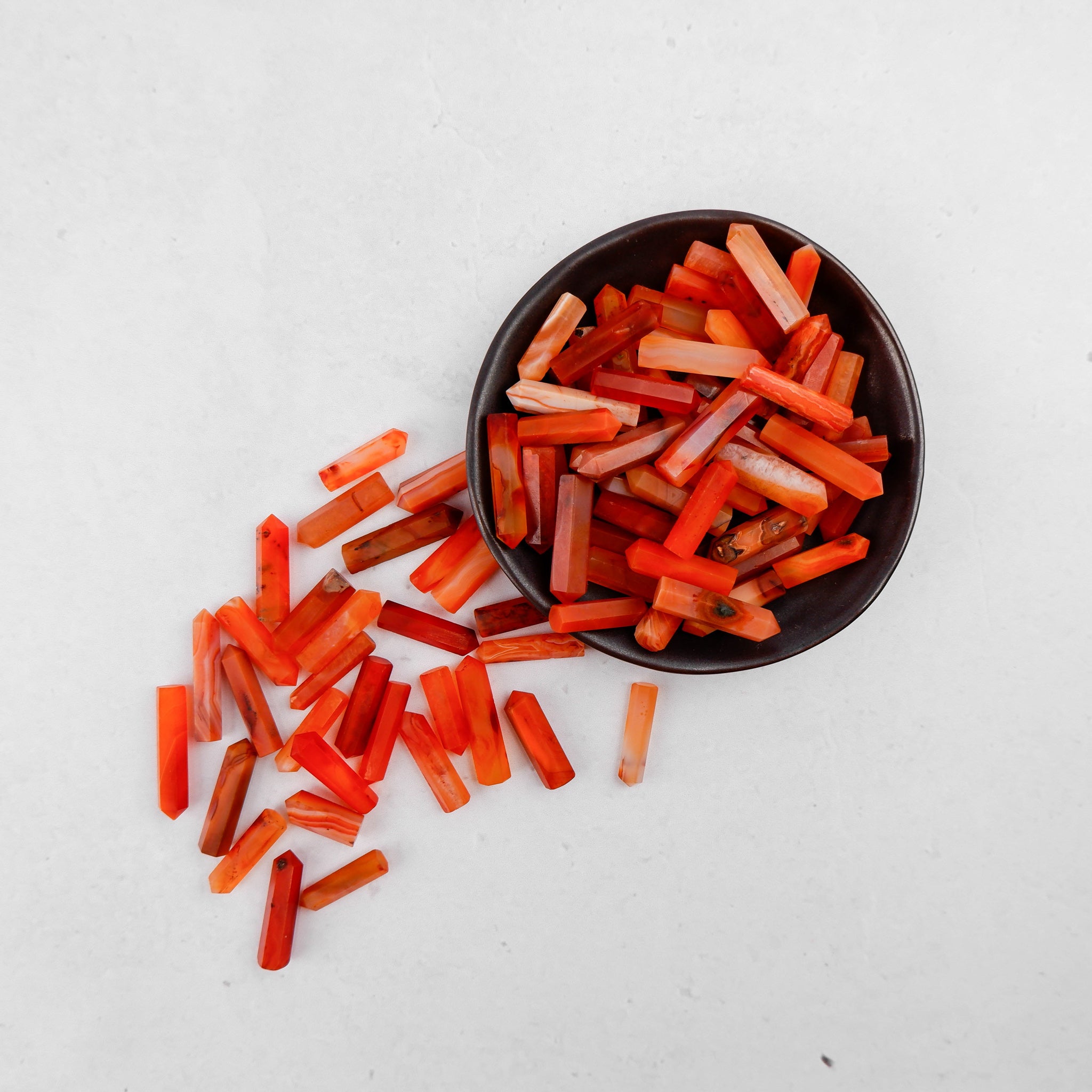 Noctis Studio Carnelian Single Gridding Point showing a polished, reddish-orange gemstone used for gridding in microblading or tattooing.
