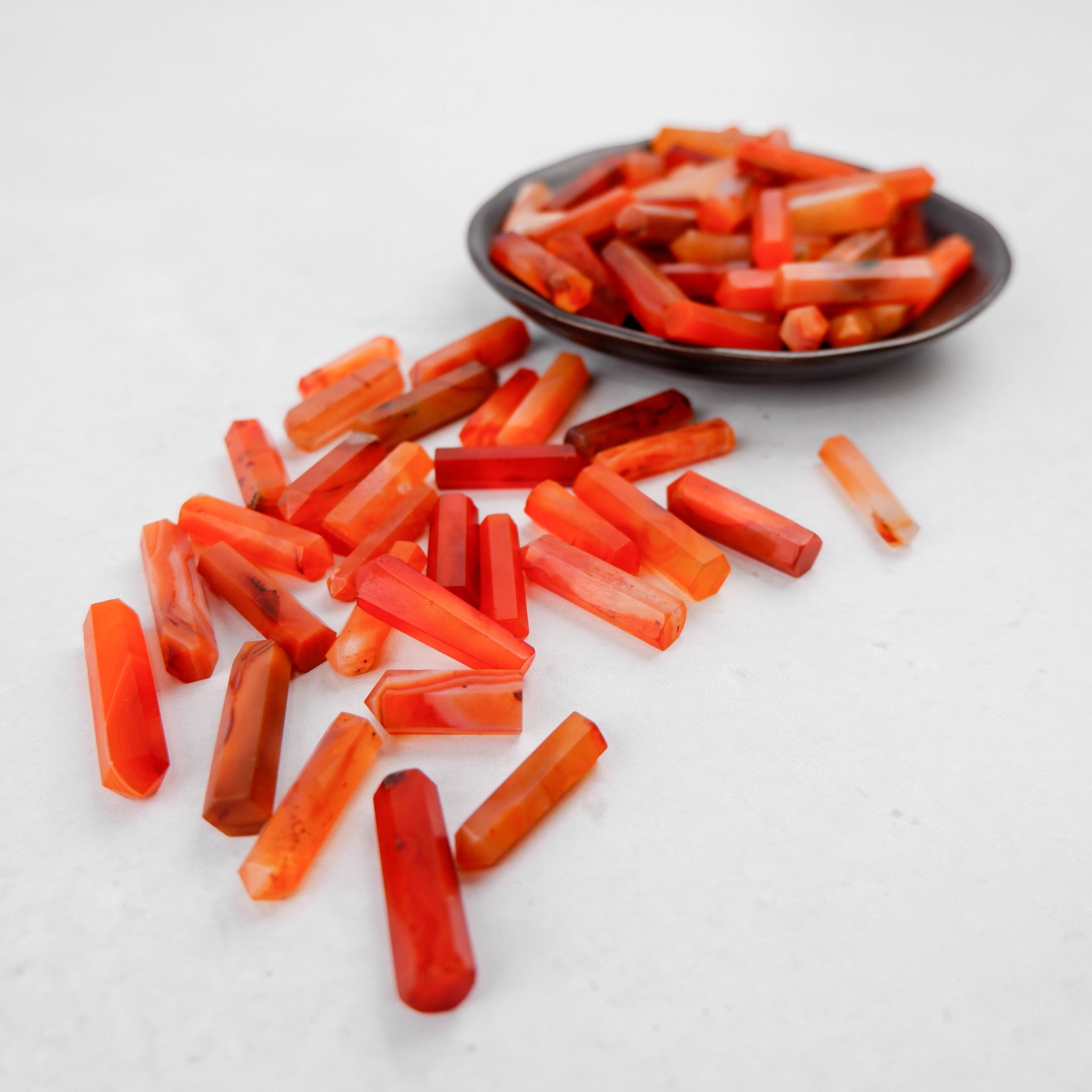 Carnelian single gridding point by Noctis Studio, a detailed jewelry-making tool with a vibrant orange gemstone appearance.