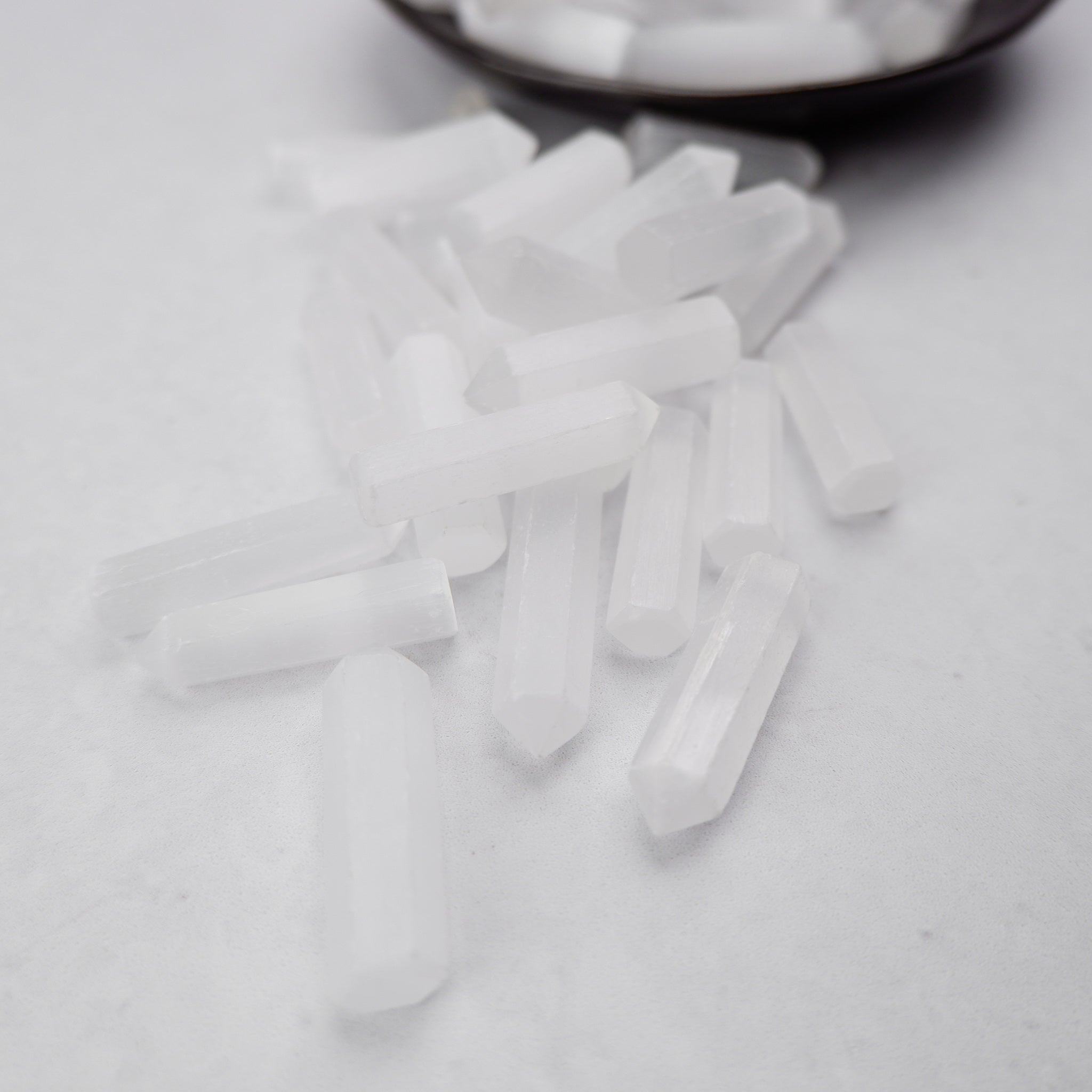 Selenite single gridding point by Noctis Studio, a clear crystal tool with pointed tip used for energy work and spiritual practices.
