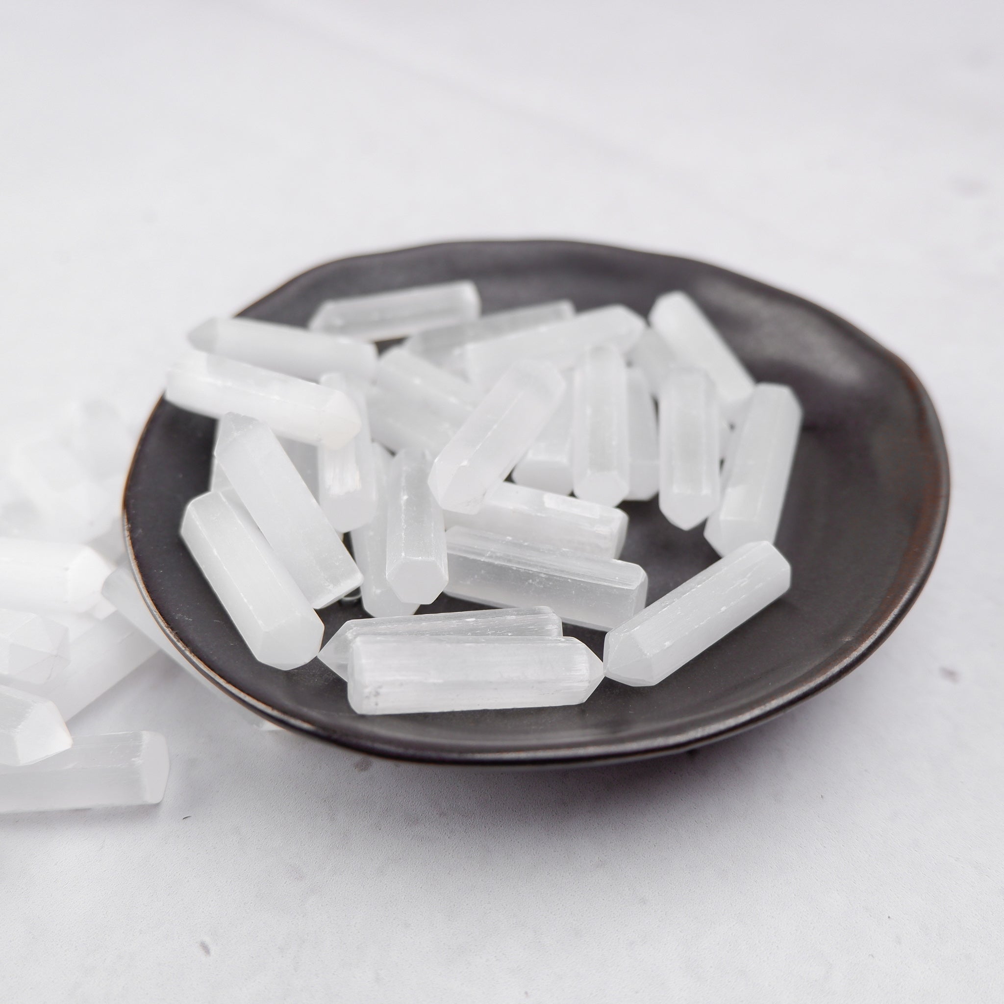Selenite single gridding point from Noctis Studio, clear crystal with pointed tip for energy work and crystal healing.