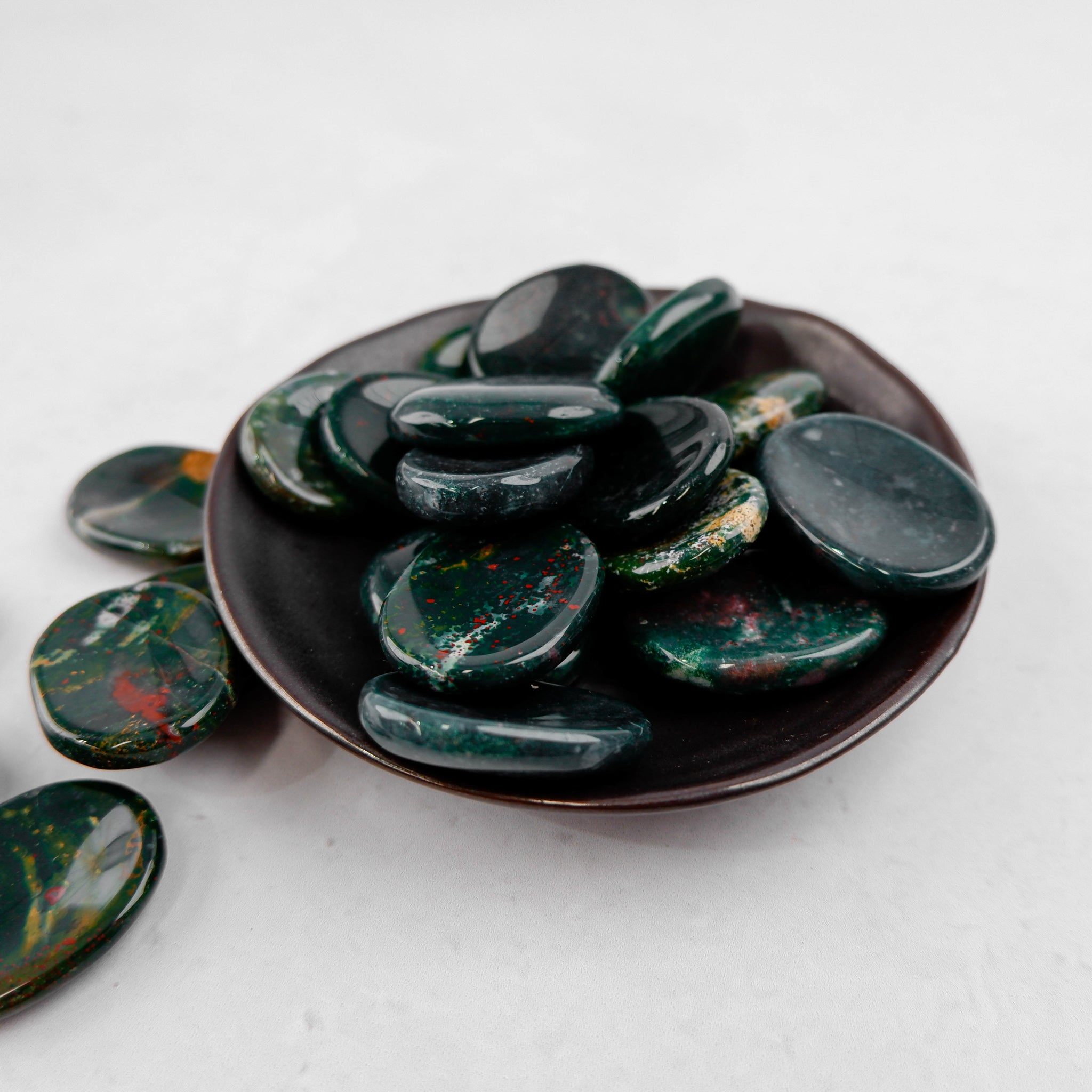 Bloodstone worry stone by Noctis Studio, smooth polished gemstone for calming meditation and stress relief.
