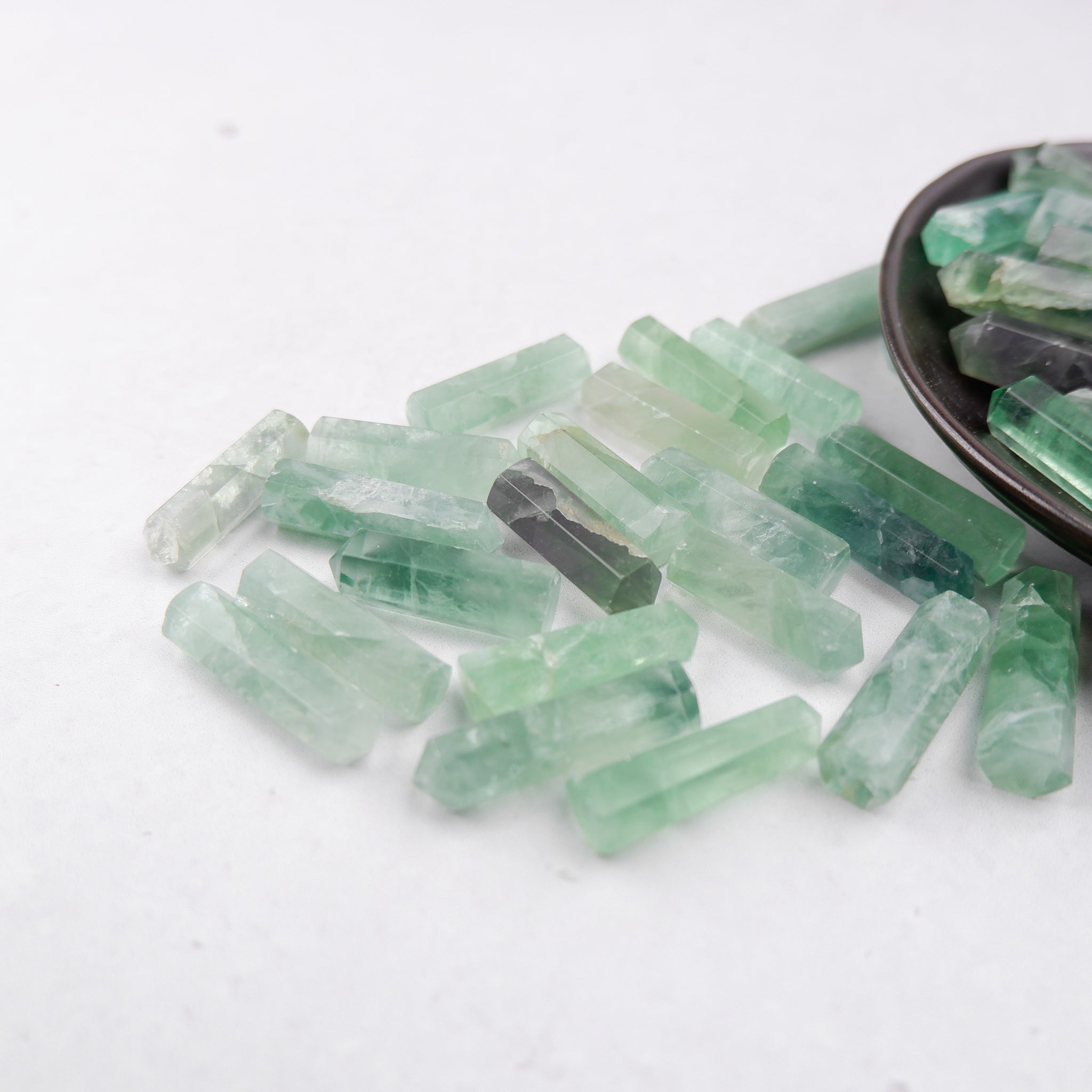Green fluorite single gridding point from Noctis Studio, featuring a polished, pointed crystal with vibrant green hues.