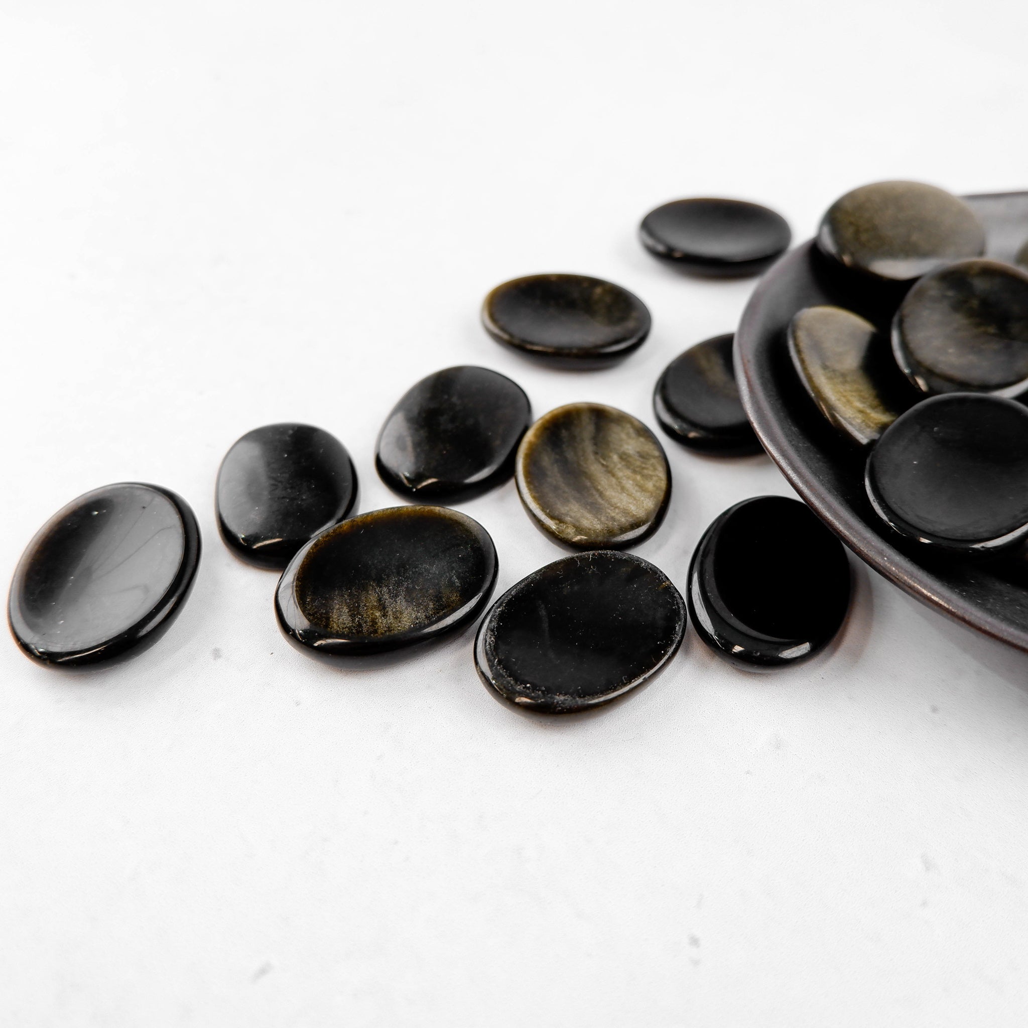 Golden Sheen Obsidian worry stone from Noctis Studio, smooth polished gemstone with shimmering golden highlights, ideal for stress relief.