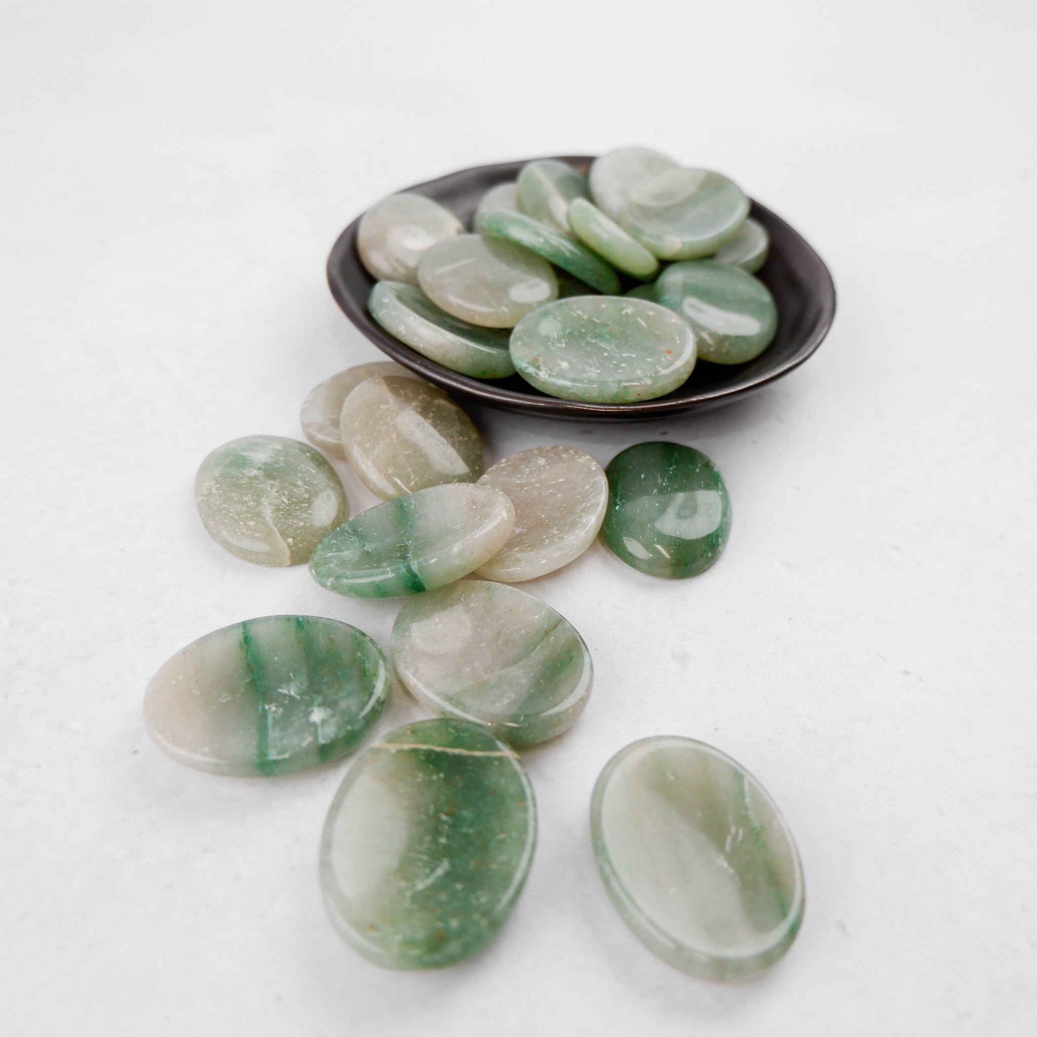 Green aventurine worry stone from Noctis Studio, smooth polished gemstone for stress relief and meditation.