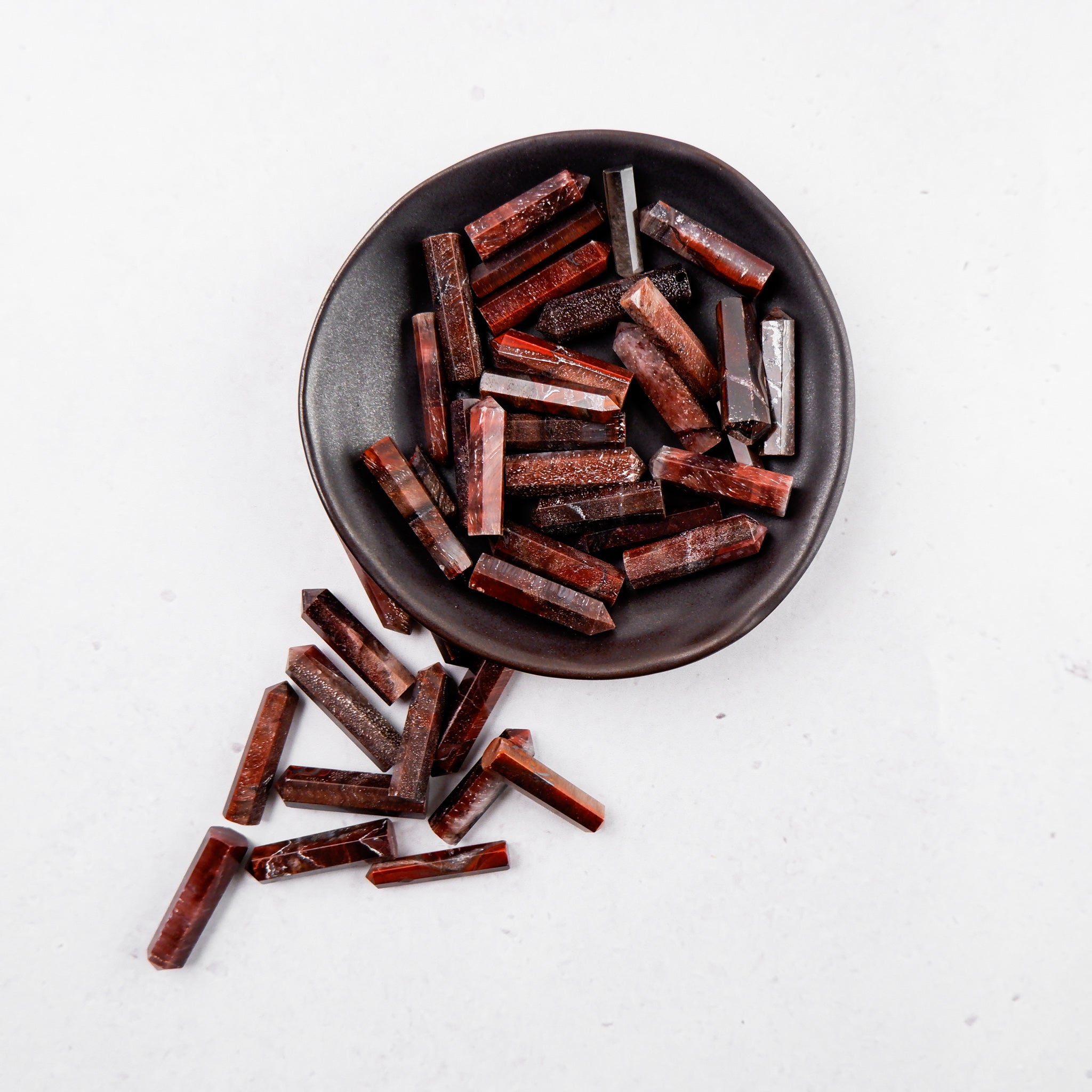 Red Tigers Eye single gridding point from Noctis Studio, featuring polished tigers eye stone with a pointed tip for detailed work.