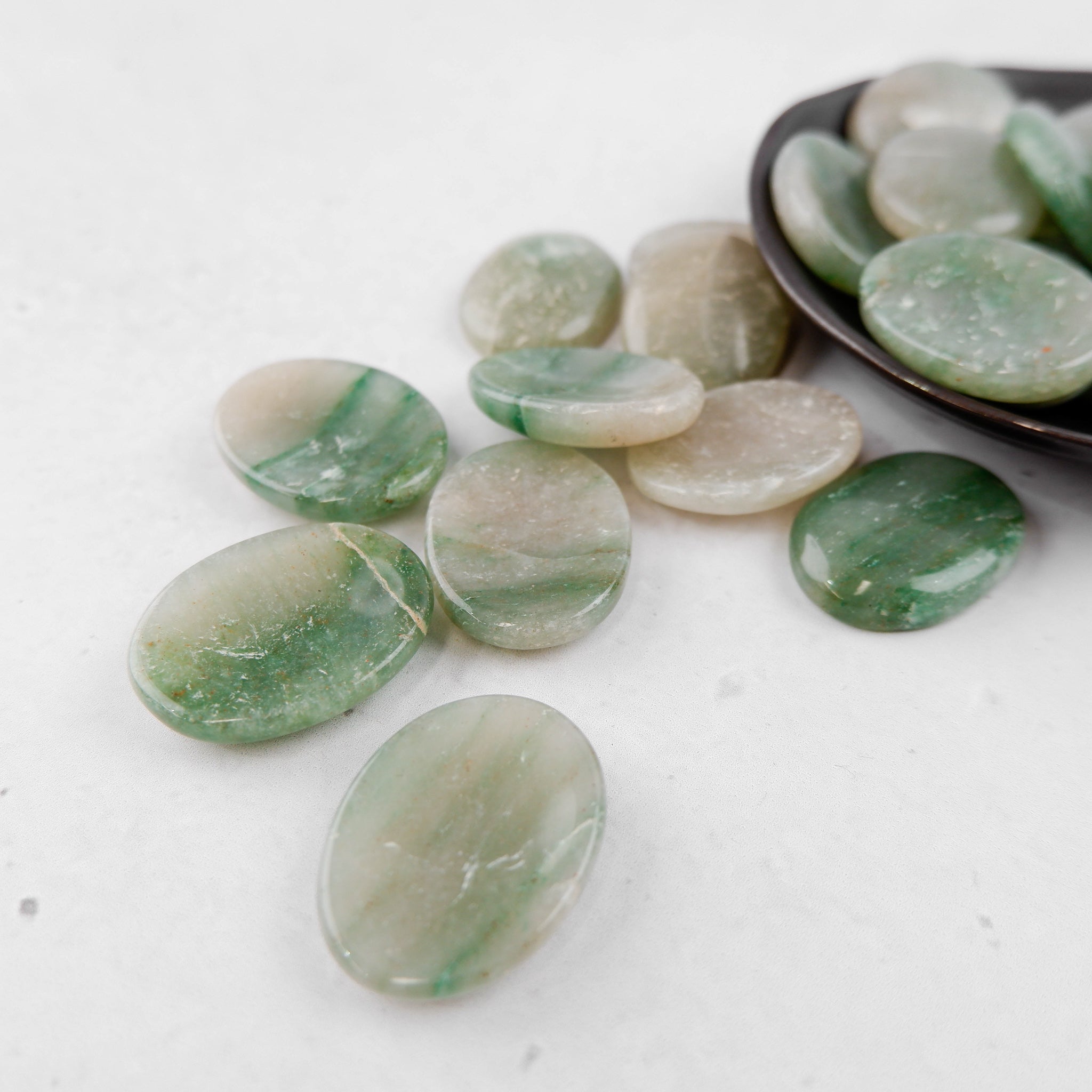 Green aventurine worry stone from Noctis Studio, smooth polished worry stone for stress relief and meditation.
