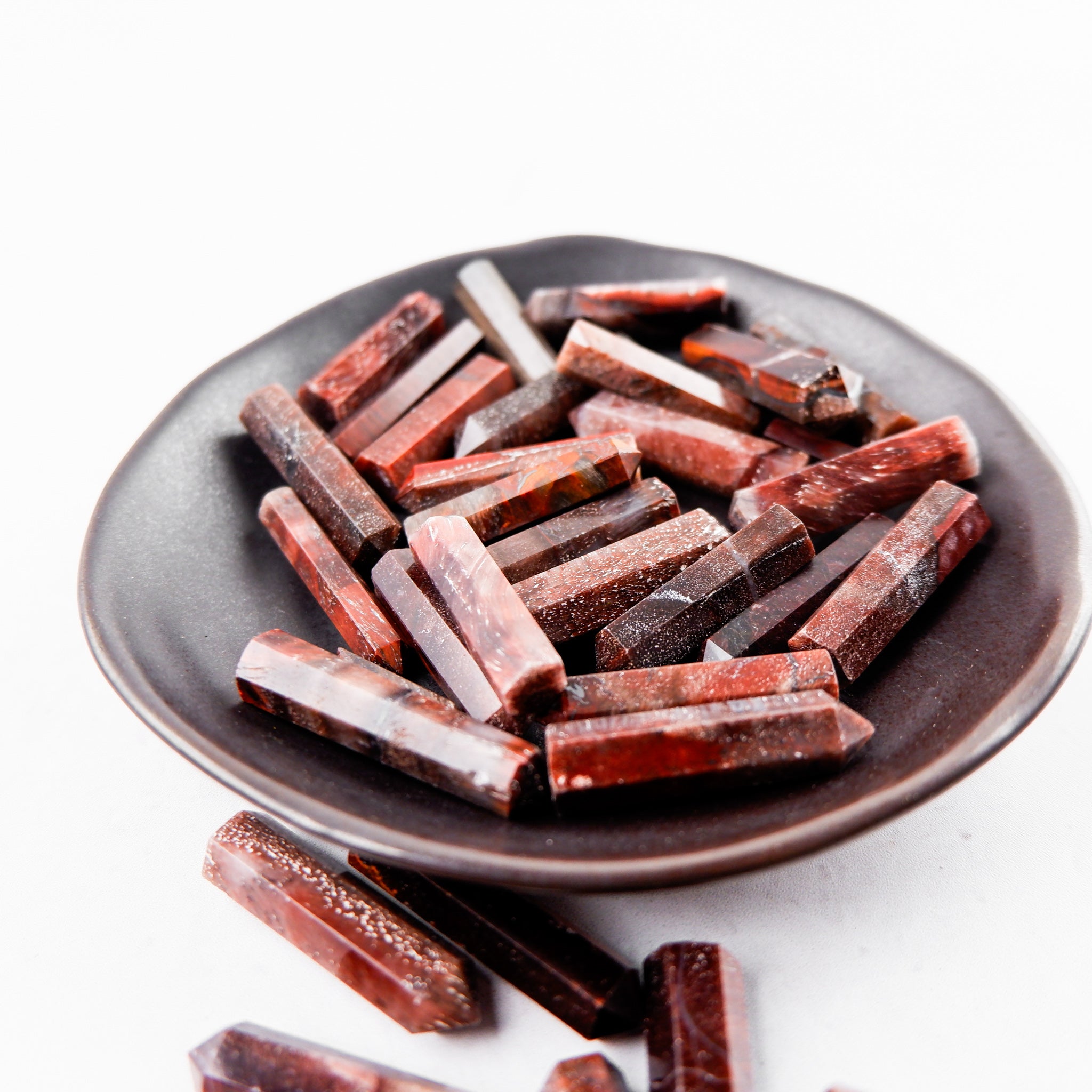 Red Tigers Eye single gridding point from Noctis Studio, featuring a polished, pointed gemstone for jewelry making or crafting.
