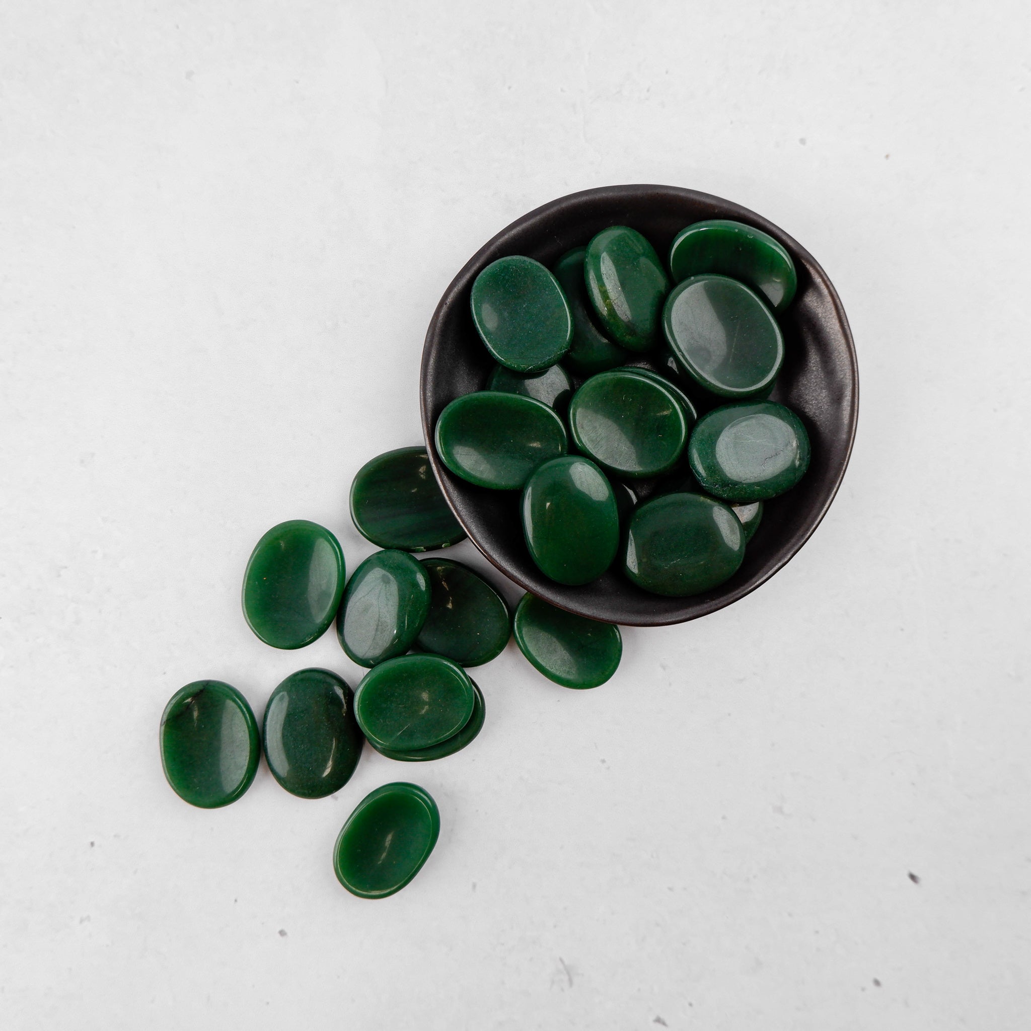 Dark green aventurine worry stone from Noctis Studio with smooth, polished surface and rounded shape for calming hand relief.