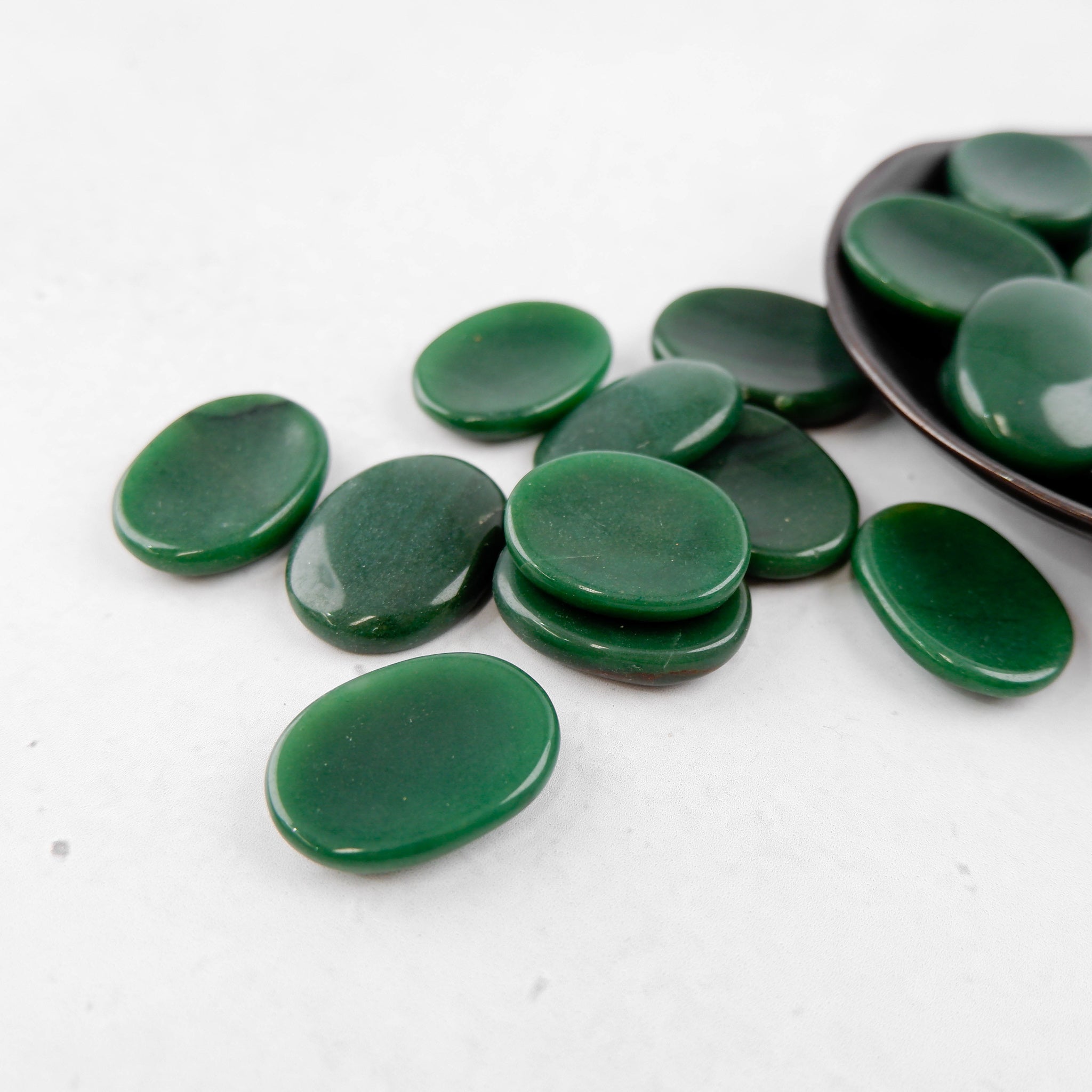 Dark green aventurine worry stone from Noctis Studio, smooth polished gemstone with rounded shape for stress relief and meditation.
