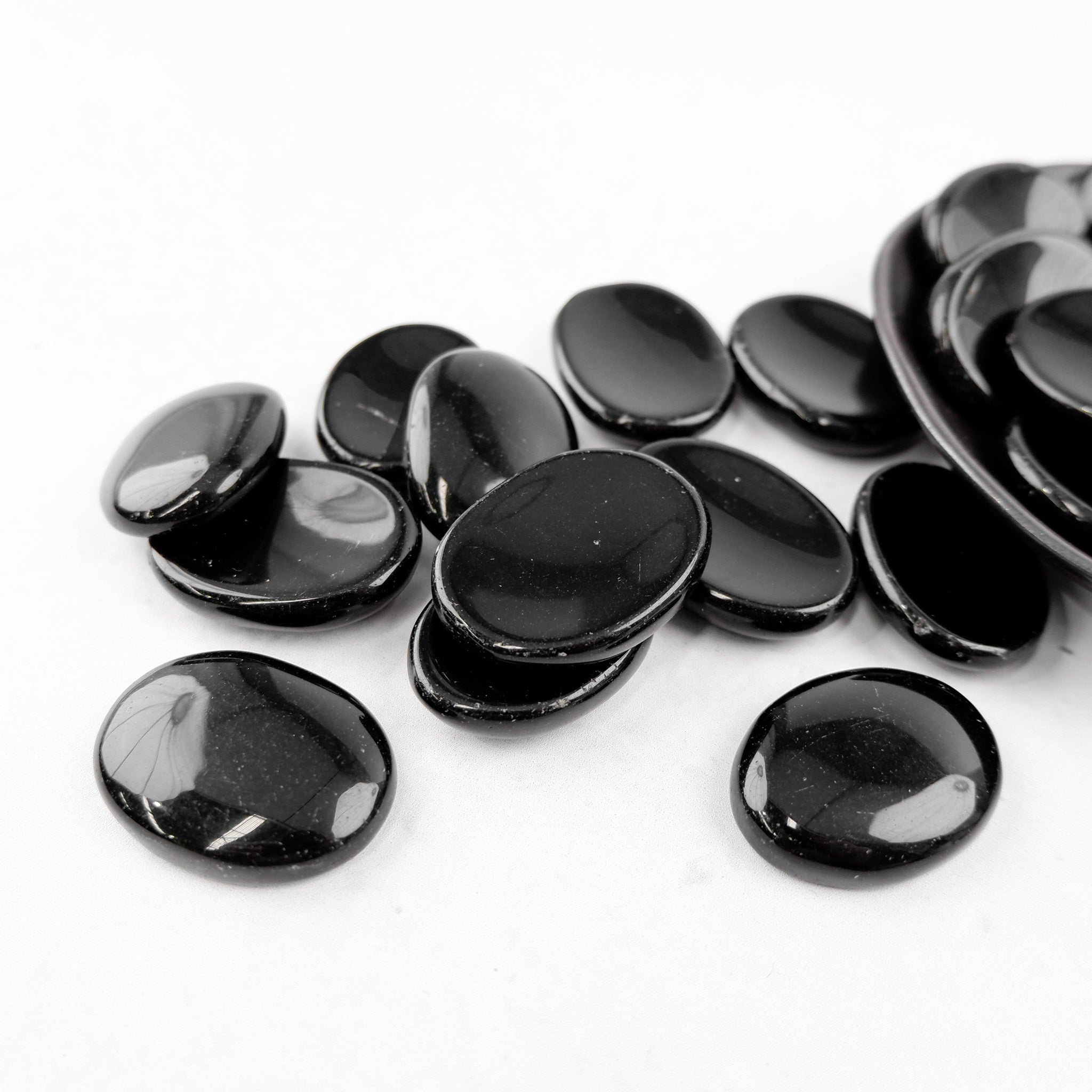 Obsidian worry stone from Noctis Studio, smooth black gemstone handheld worry stone for stress relief and meditation.