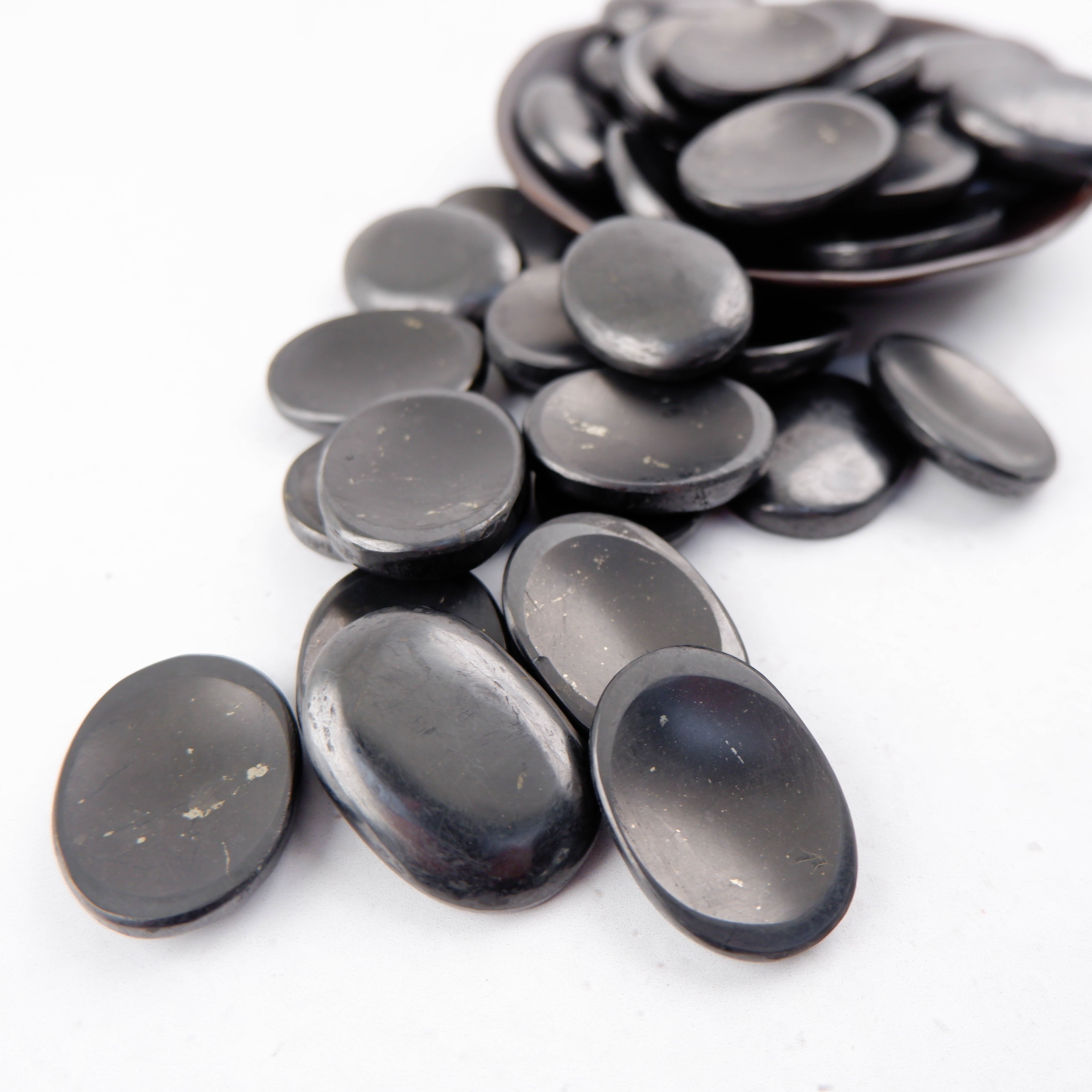 Shungite worry stone from Noctis Studio, smooth black gemstone with natural polished finish for stress relief and meditation.