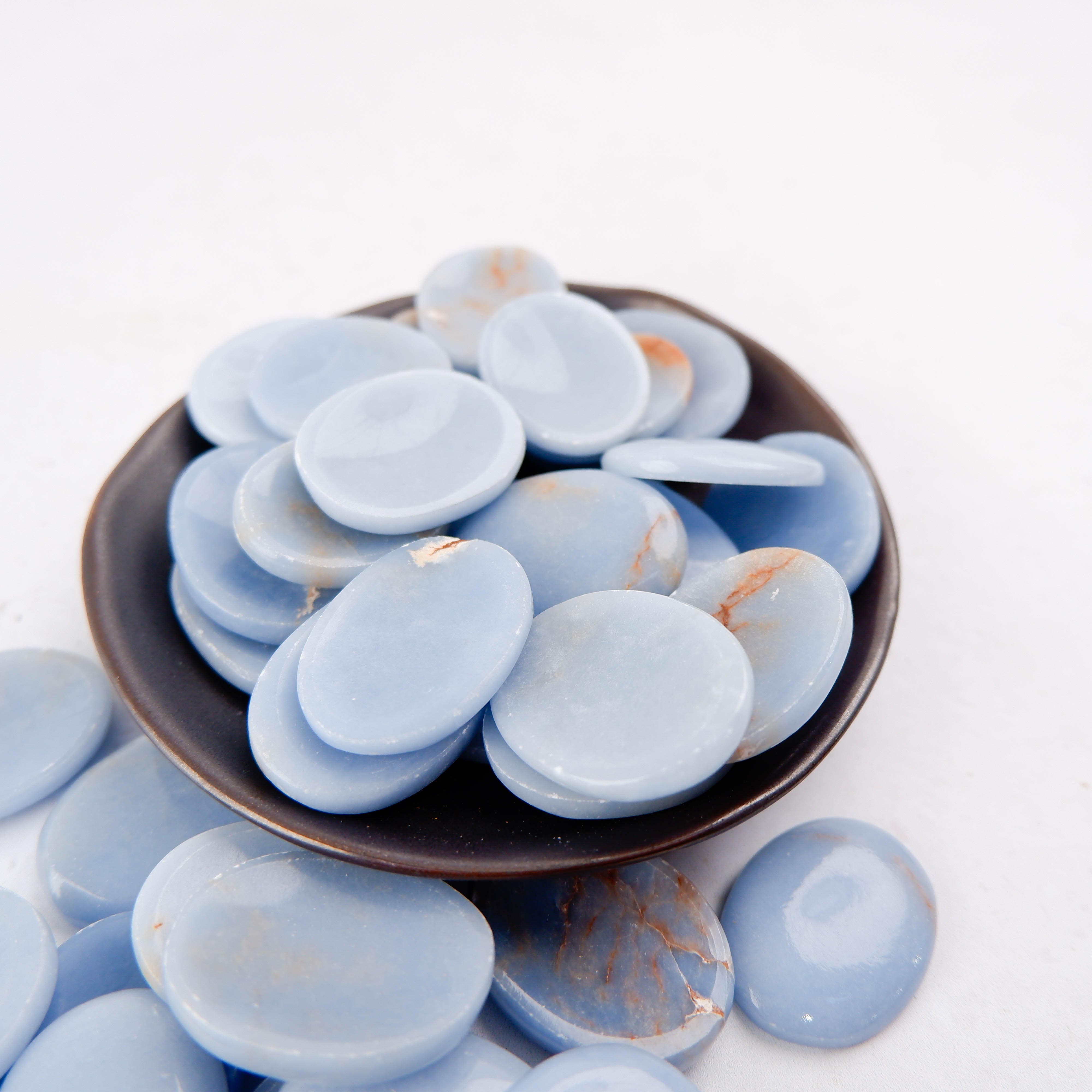 Angelite worry stone from Noctis Studio, smooth polished blue gemstone for stress relief and meditation.