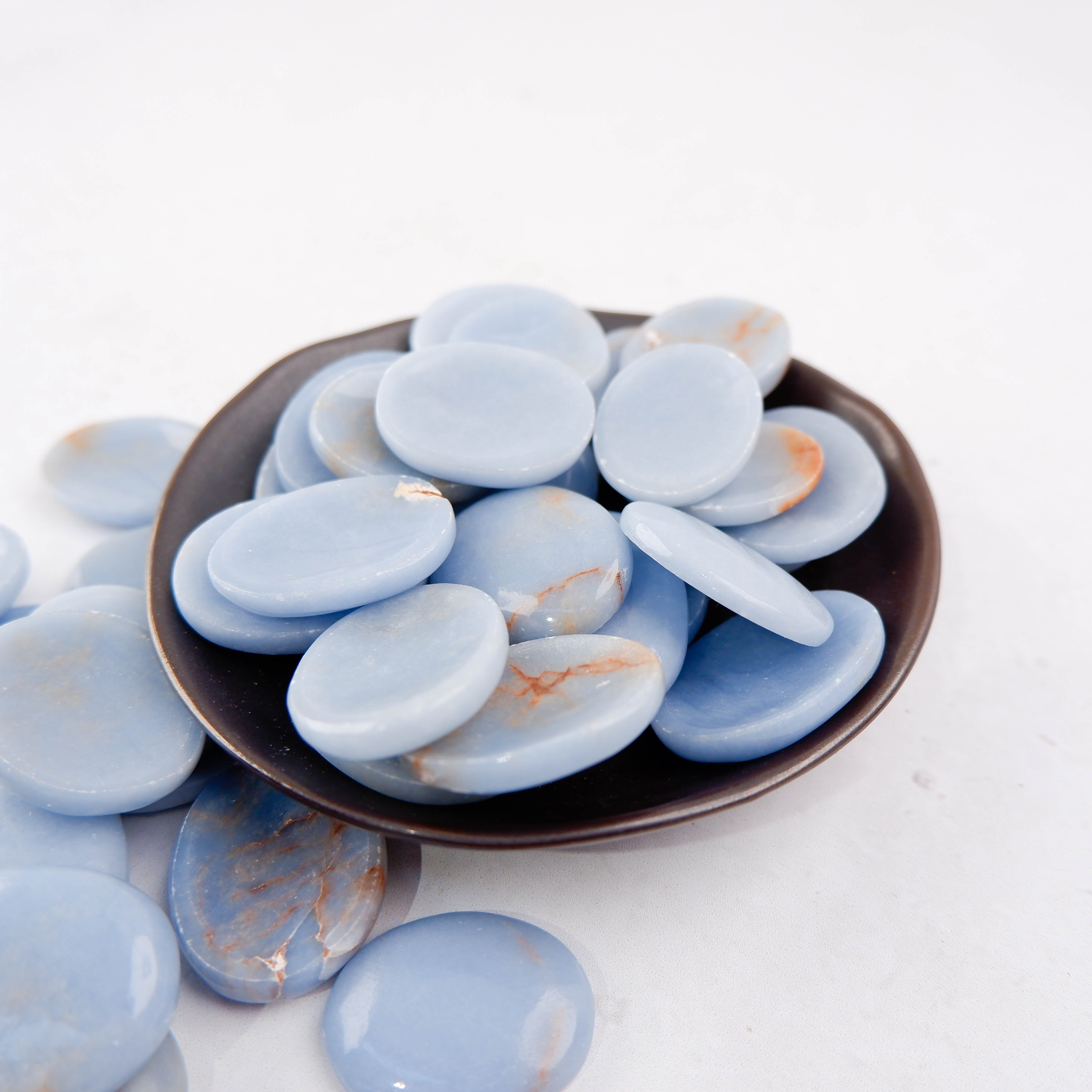 Angelite worry stone from Noctis Studio, smooth blue healing crystal in a polished worry stone shape.