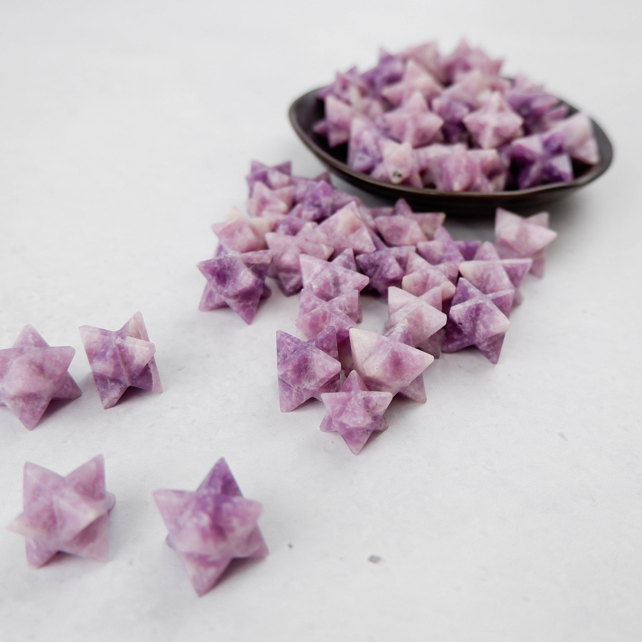 Lepidolite star gemstone from Noctis Studio, polished and smooth with a vibrant purple hue and natural mineral patterns.