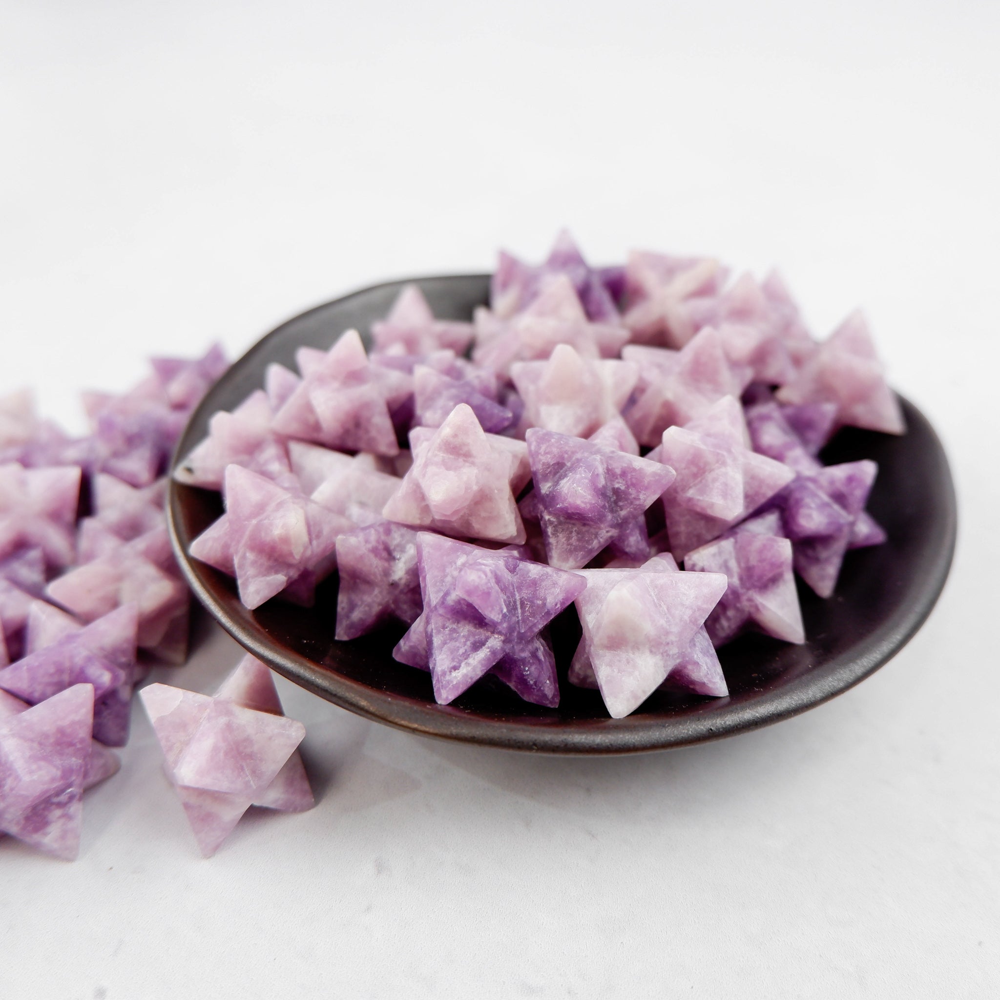 Lepidolite star crystal from Noctis Studio, featuring a polished, star-shaped mineral with purple and lavender hues.