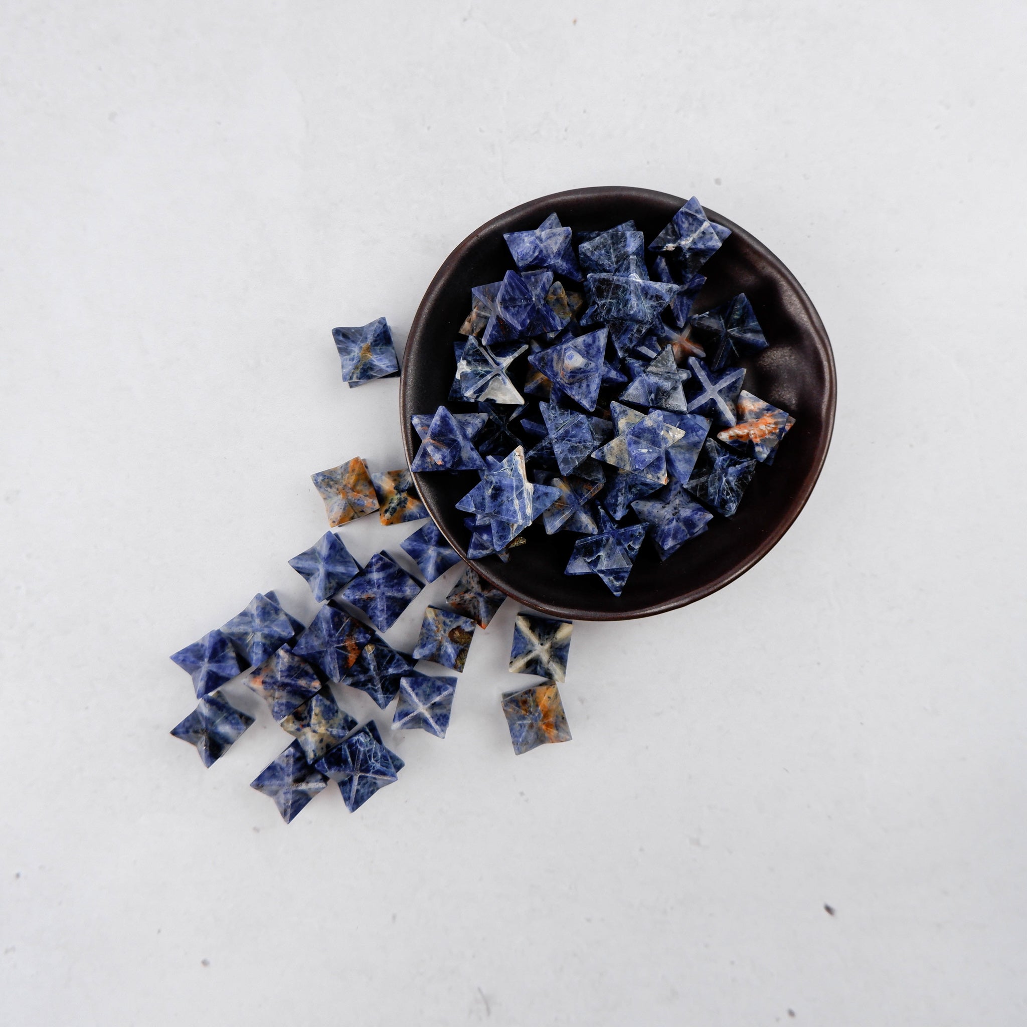 Sodalite star sculpture by Noctis Studio, polished blue mineral with natural white veining, displayed on a neutral background.