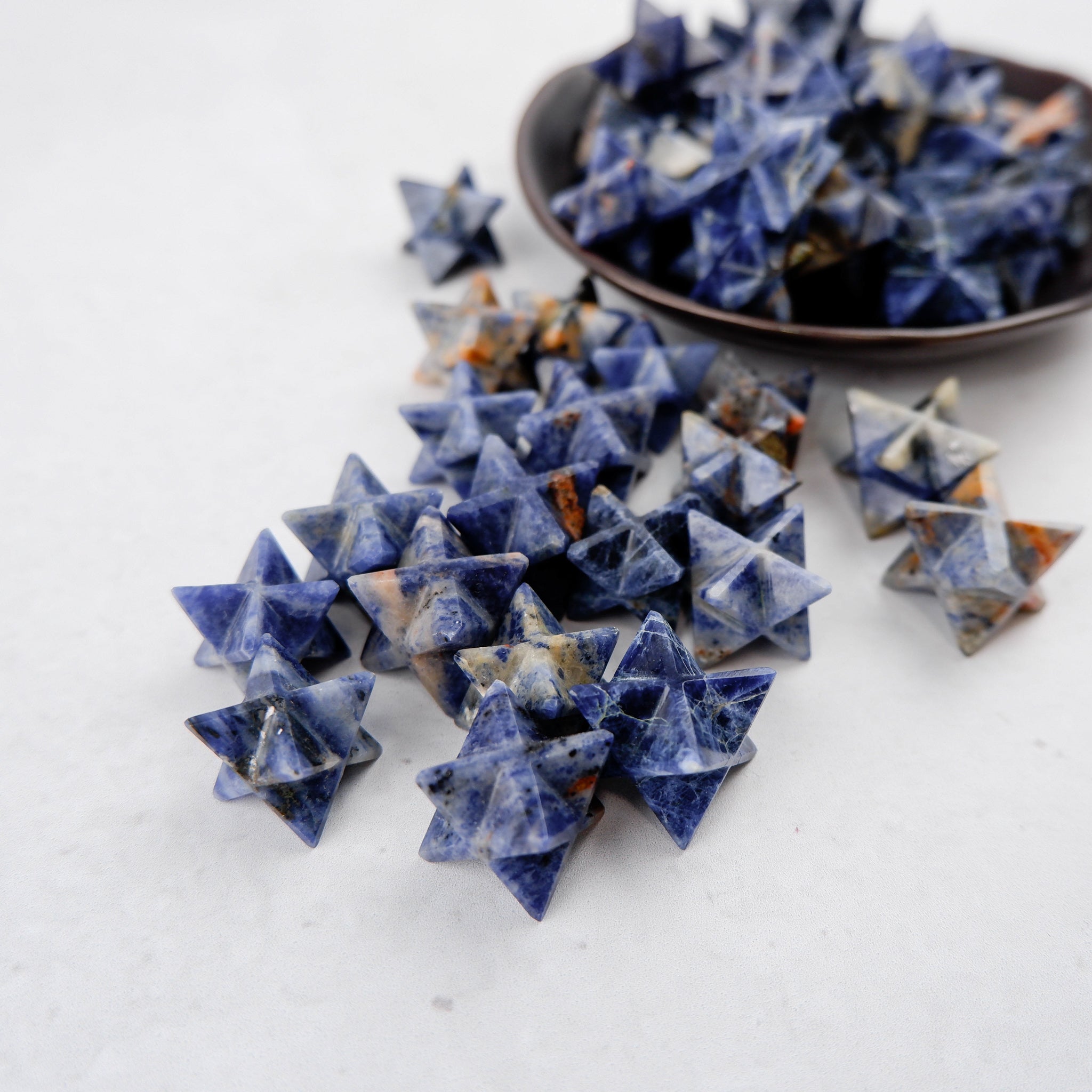 Sodalite star sculpture by Noctis Studio, featuring deep blue and white mineral patterns, polished and displayed against a neutral background.
