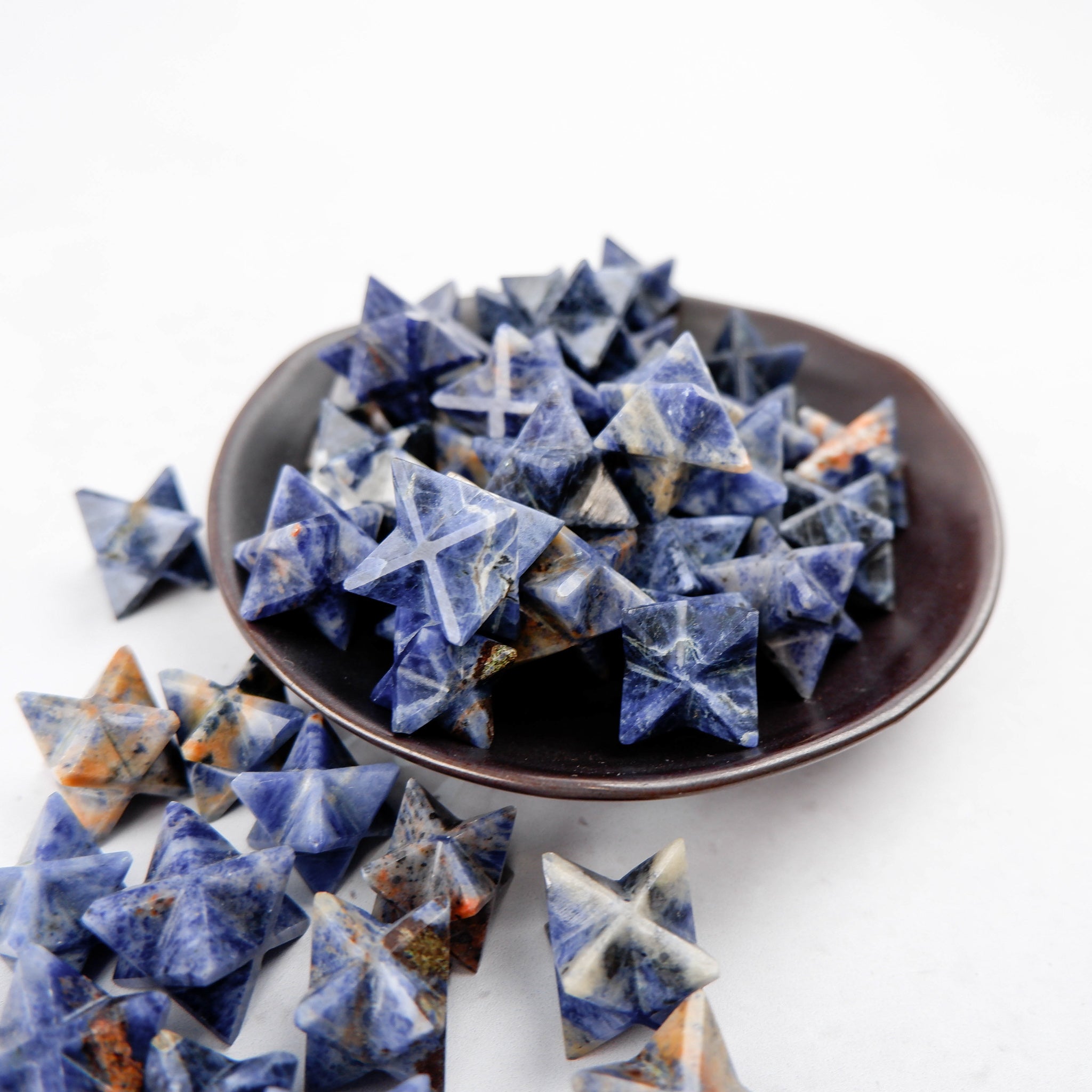 Blue sodalite star sculpture by Noctis Studio, featuring a polished stone with natural veining and a star shape.
