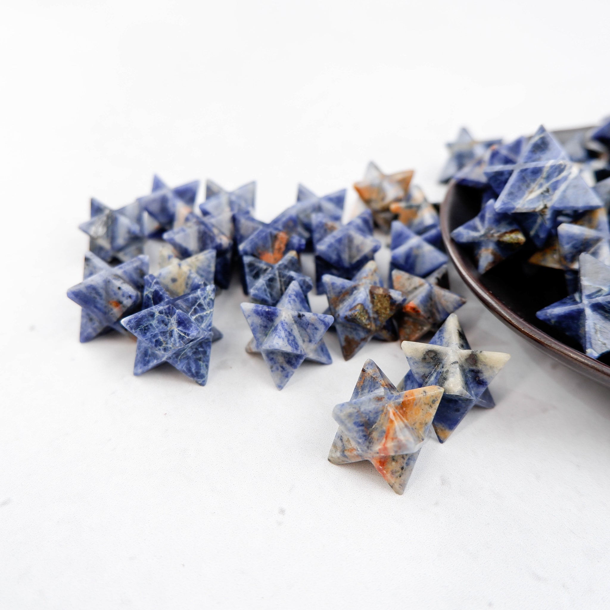 Sodalite star gemstone sculpture by Noctis Studio, featuring deep blue and white mineral patterns on a polished star-shaped stone.