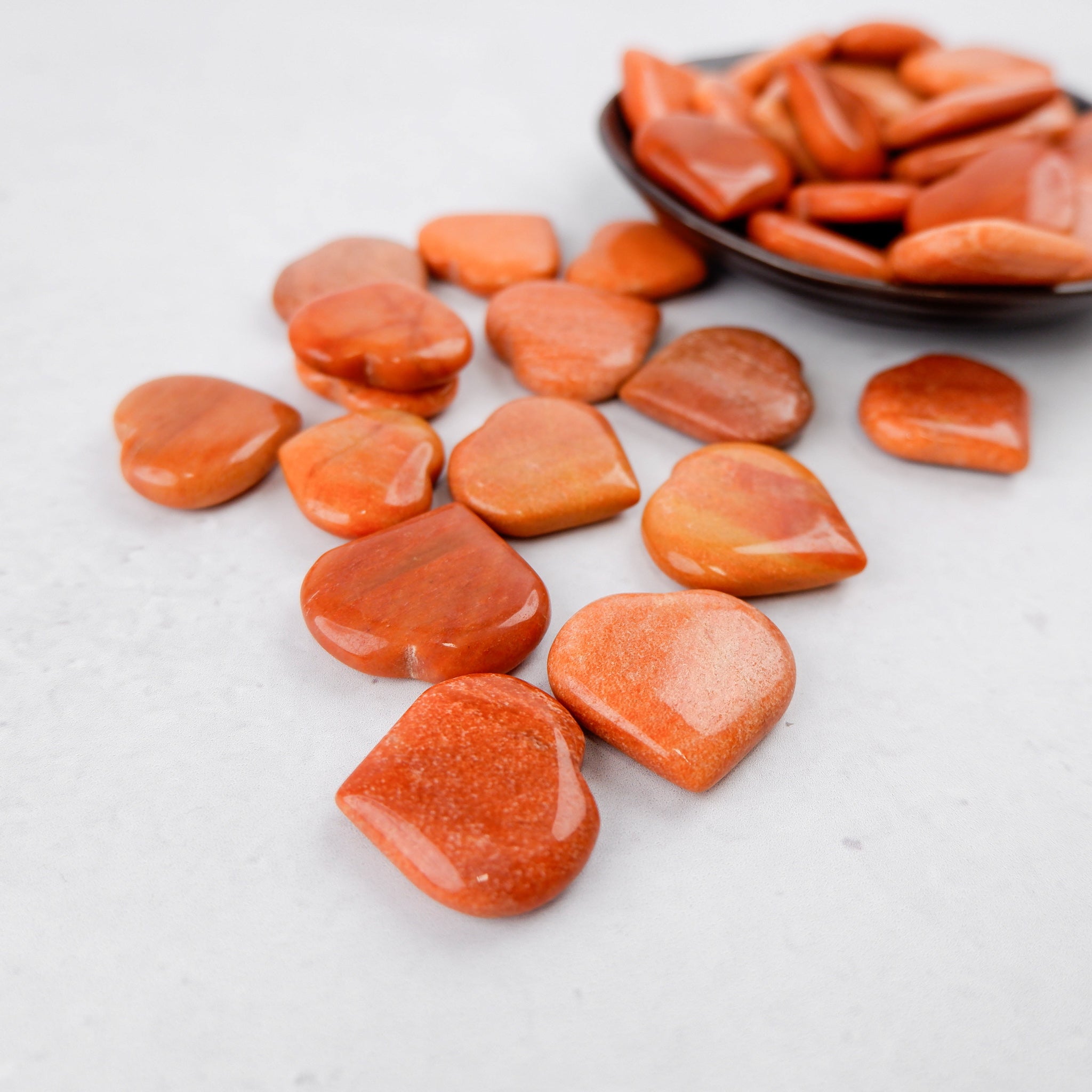 Peach aventurine heart sculpture by Noctis Studio, smooth polished stone with warm orange tones and natural veining.