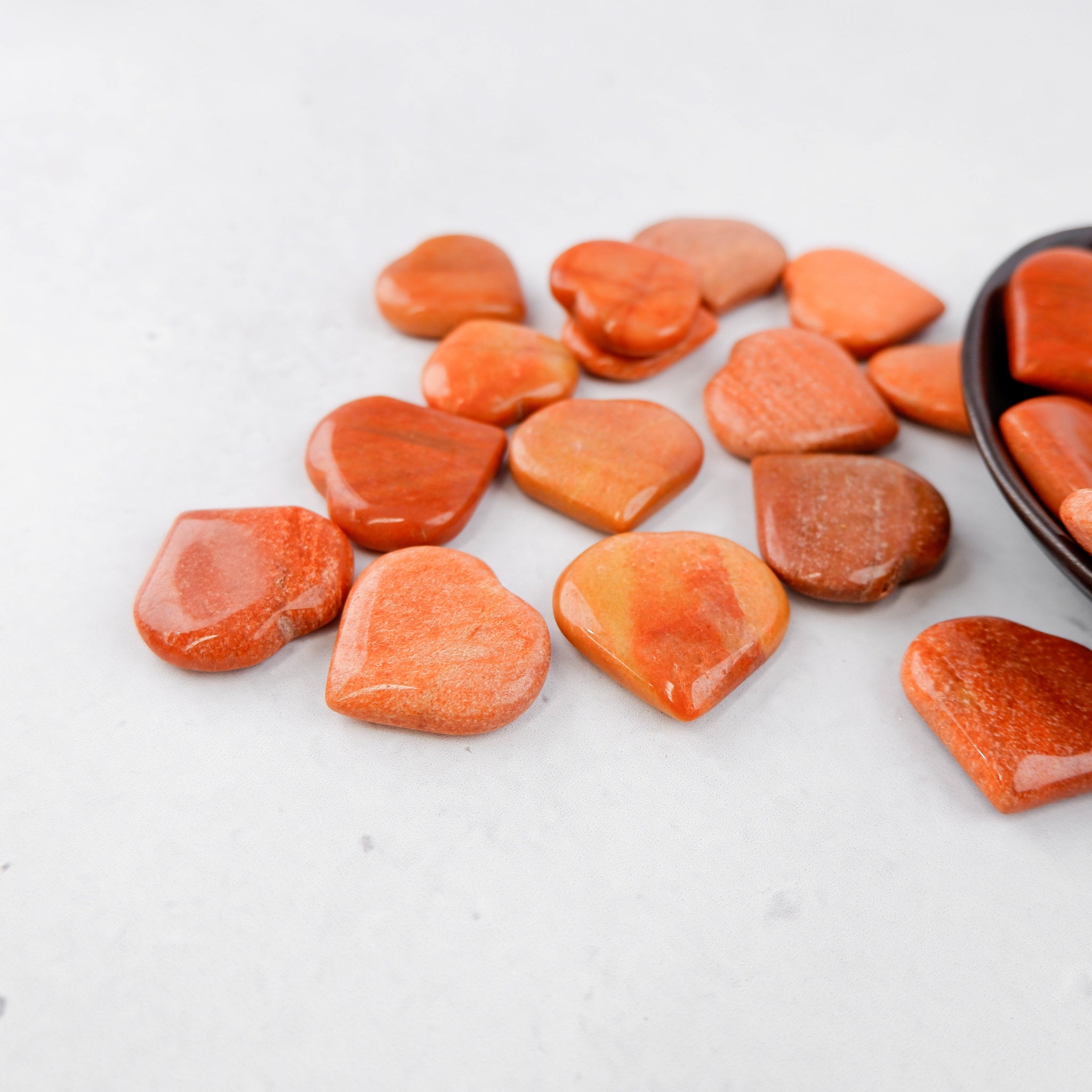 Peach aventurine heart-shaped sculpture by Noctis Studio, smooth polished stone with natural gemstone patterns.